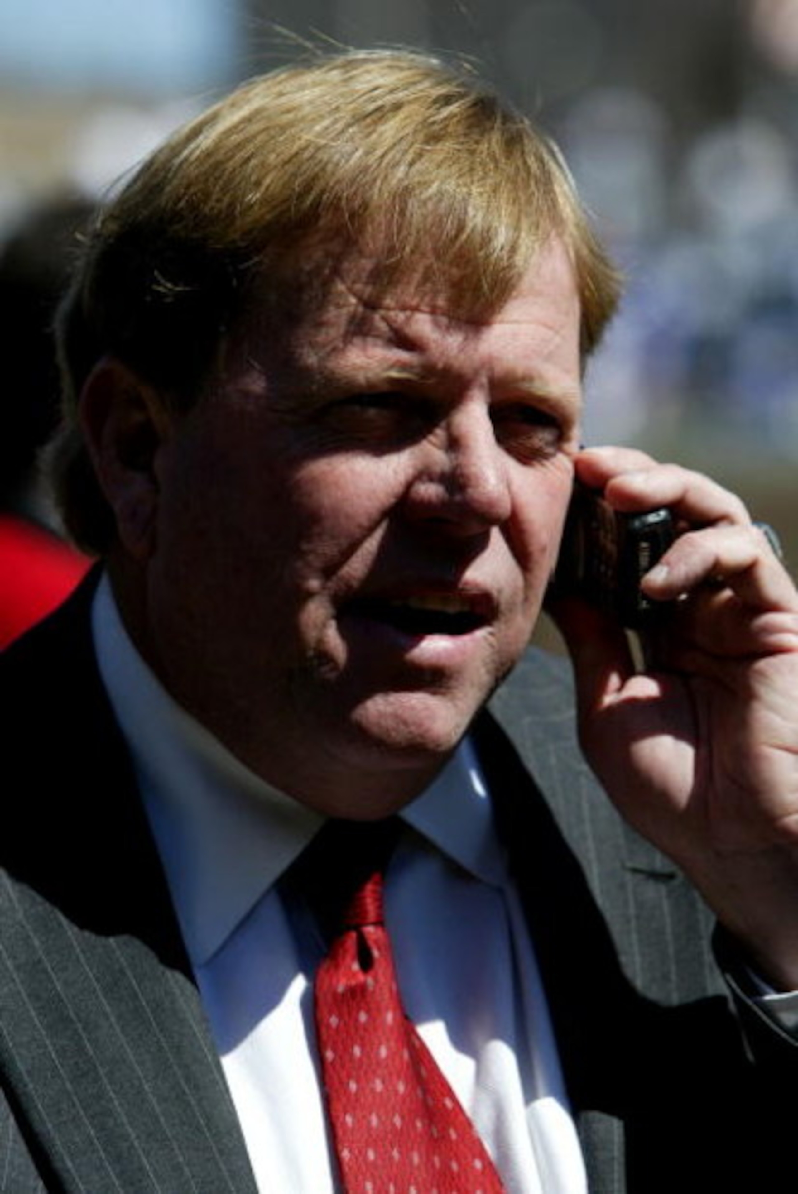 CHICAGO - APRIL 8:  General Manager Jim Hendry of the Chicago Cubs works the phone before the Opening Day game between the Cubs and the Milwaukee Brewers on April 8, 2005 at Wrigley Field in Chicago, Illinois.  (Photo by Jonathan Daniel/Getty Images)