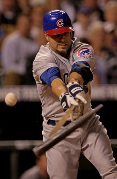 DENVER - APRIL 23:  Reed Johnson #9 of the Chicago Cubs breaks his bat as he fouls off a ball against the Colorado Rockies at Coors Field on April 23, 2008 in Denver, Colorado. The Cubs defeated the Rockies 7-6 in 10 innings to secure the club's 10,000th 