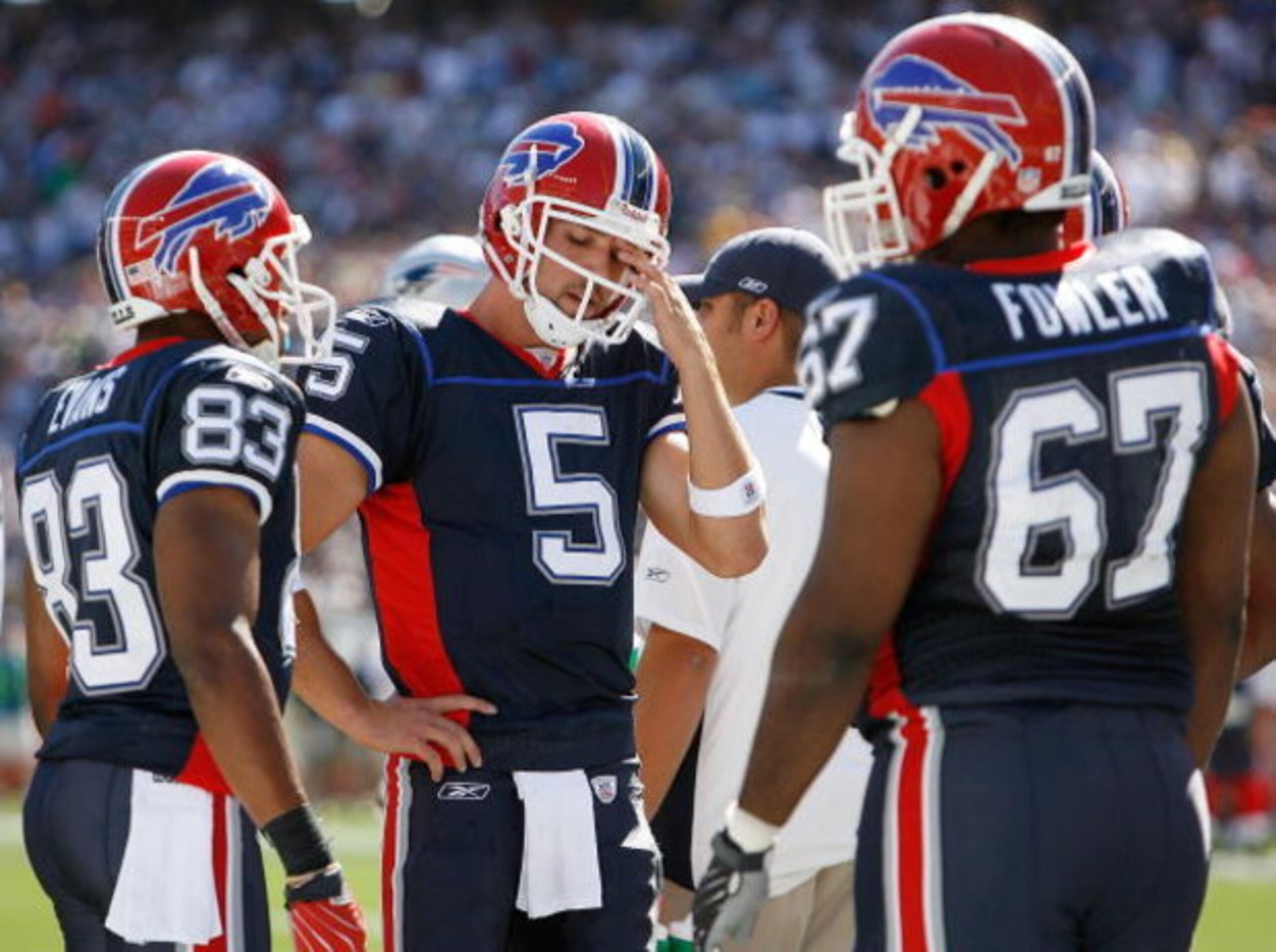 FOXBORO, MA - SEPTEMBER 23:  Quarterback Trent Edwards #5 of the Buffalo Bills rubs his eye as teammates Lee Evan #83 and Melvin Fowler #67 look on during a game against the Buffalo Bills at Gillette Stadium September 23, 2007 in Foxboro, Massachusetts.  