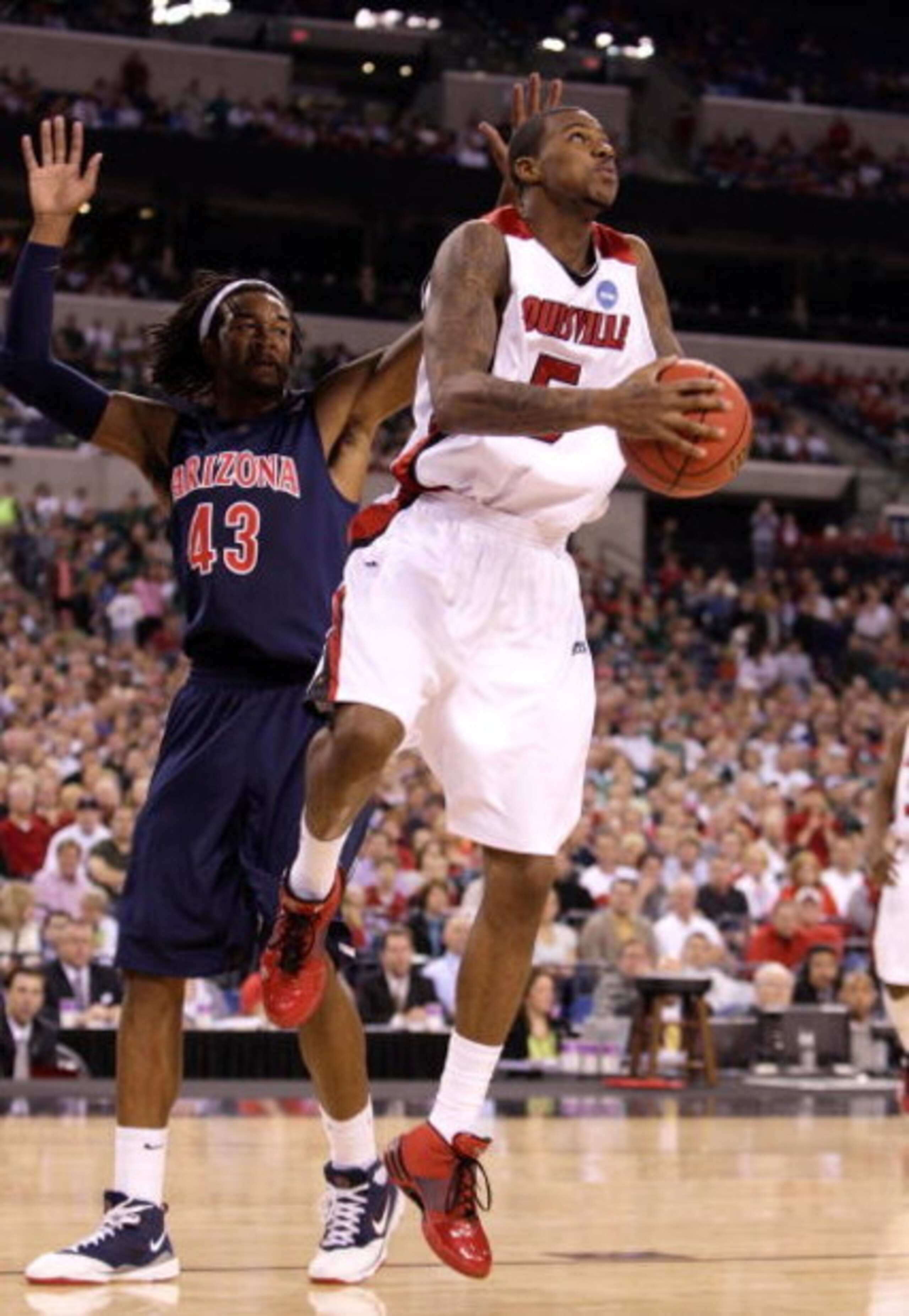 INDIANAPOLIS - MARCH 27:  Earl Clark #5 of the Louisville Cardinals drives for a shot attempt against Jordan Hill #43 of the Arizona Wildcats during the third round of the NCAA Division I Men's Basketball Tournament at the Lucas Oil Stadium on March 27, 2
