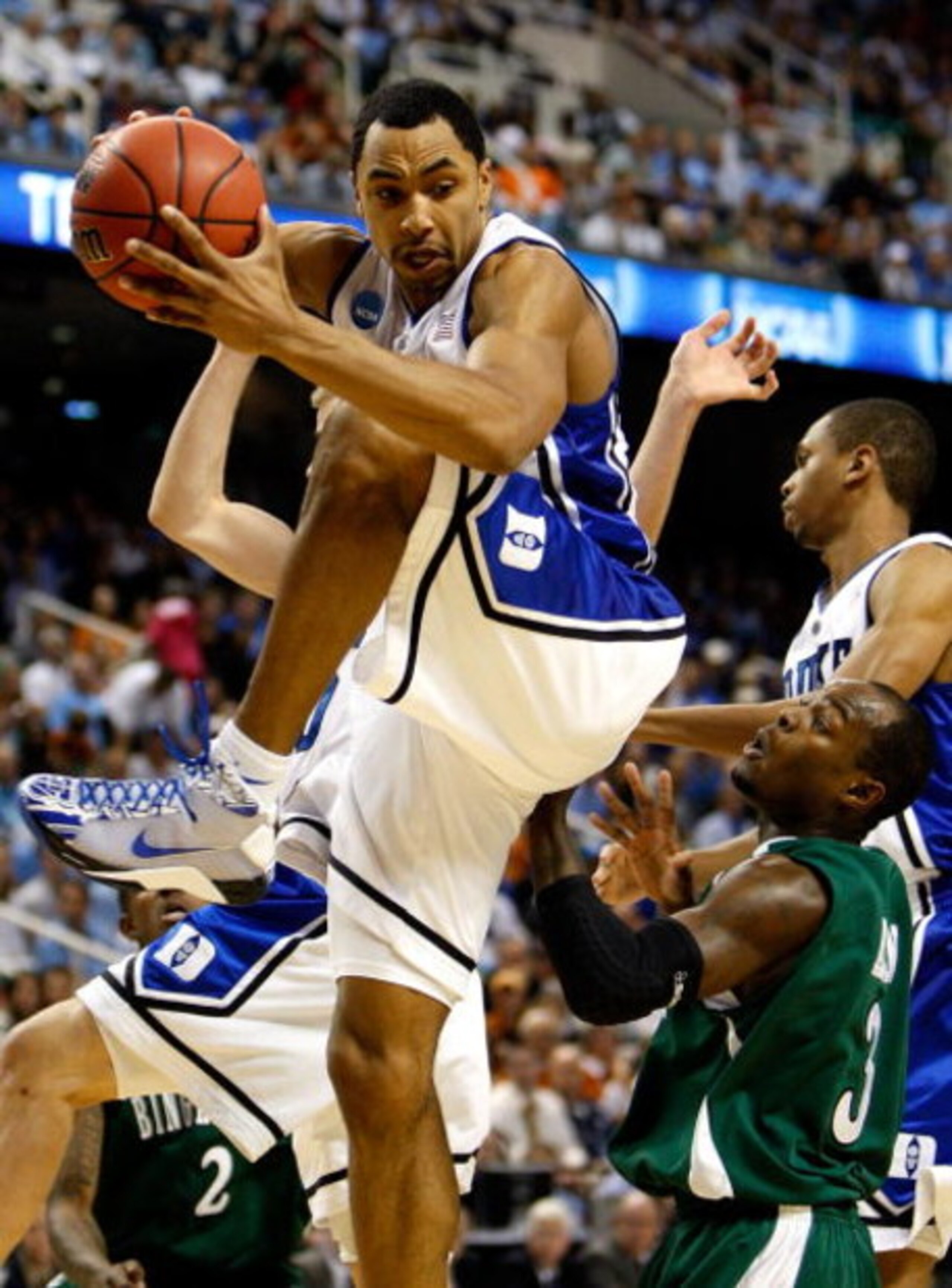 GREENSBORO, NC - MARCH 19:  Gerald Henderson #15 of the Duke Blue Devils grabs a rebound against Malik Alvin #3 of the Binghamton Bearcats during the first round of the NCAA Division I Men's Basketball Tournament at the Greensboro Coliseum on March 19, 20