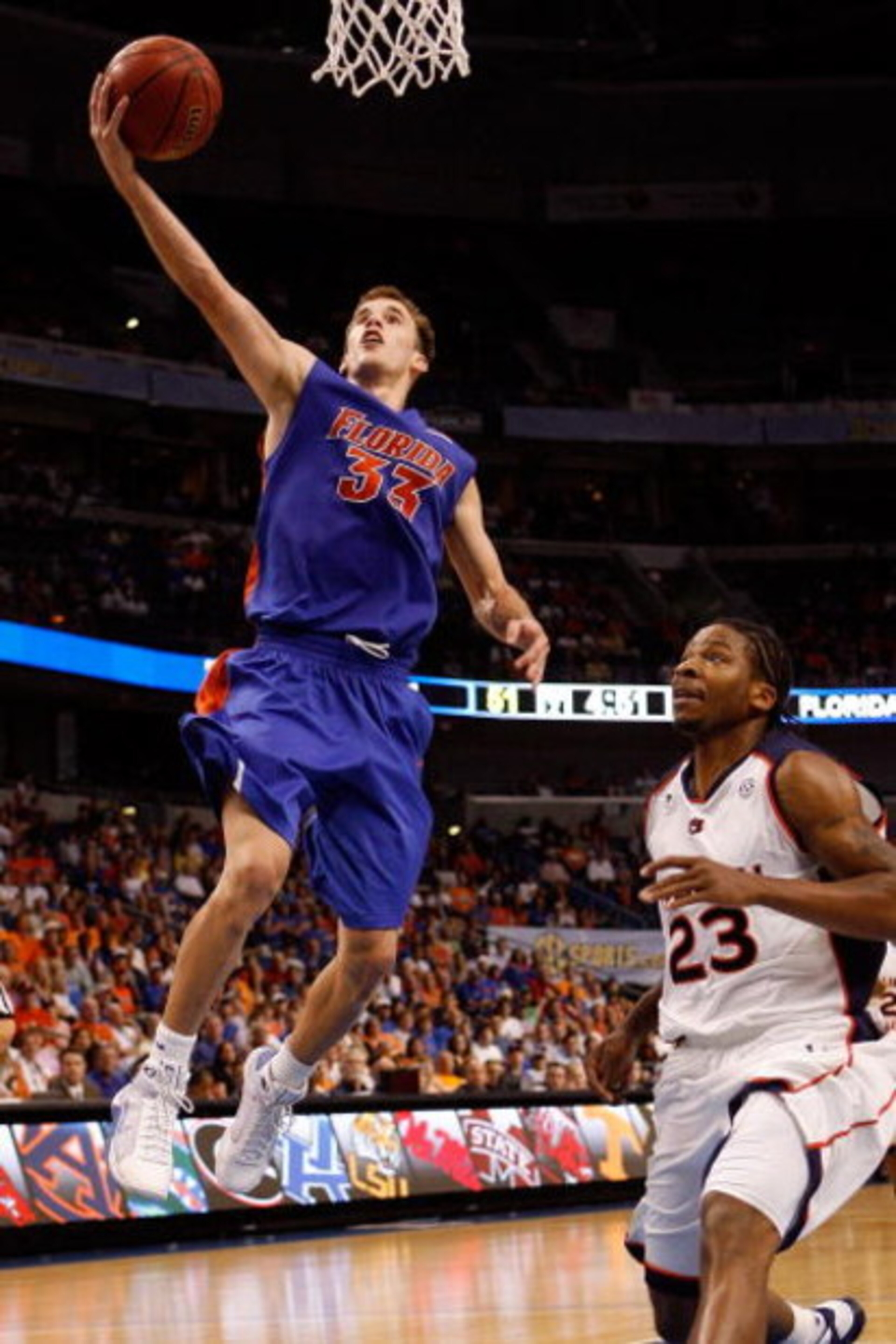 TAMPA, FL - MARCH 13:  Nick Calathes #33 of the Florida Gators makes a layup over Quantez Robertson #23 of the Auburn Tigers during the quaterfinal round of the SEC Men's Basketball Tournament on March 13, 2009 at The St. Pete Times Forum in Tampa, Florid