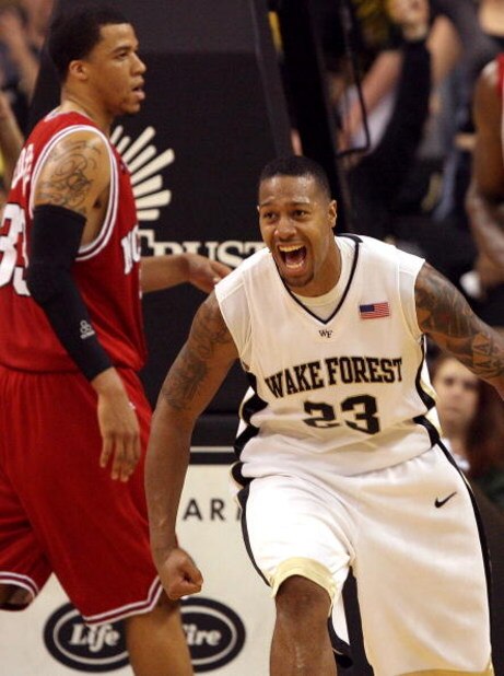 WINSTON-SALEM, NC - FEBRUARY 26:  Brandon Costner #33 of the North Carolina State Wolfpack can only watch as James Johnson #23 of the Wake Forest Demon Deacons celebrates after a dunk giving the Demon Deacons a 85-78 victory at Lawrence Joel Coliseum on F