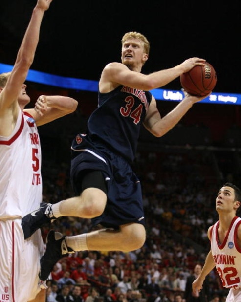 MIAMI - MARCH 20:  Forward Chase Budinger #34 (R) of the University of Arizona Wildcats takes a shot over  center Luke Nevill #50 (L) of the University of Utah Runnin' Utes  during the first round of the NCAA Division I Men's Basketball Tournament at the 
