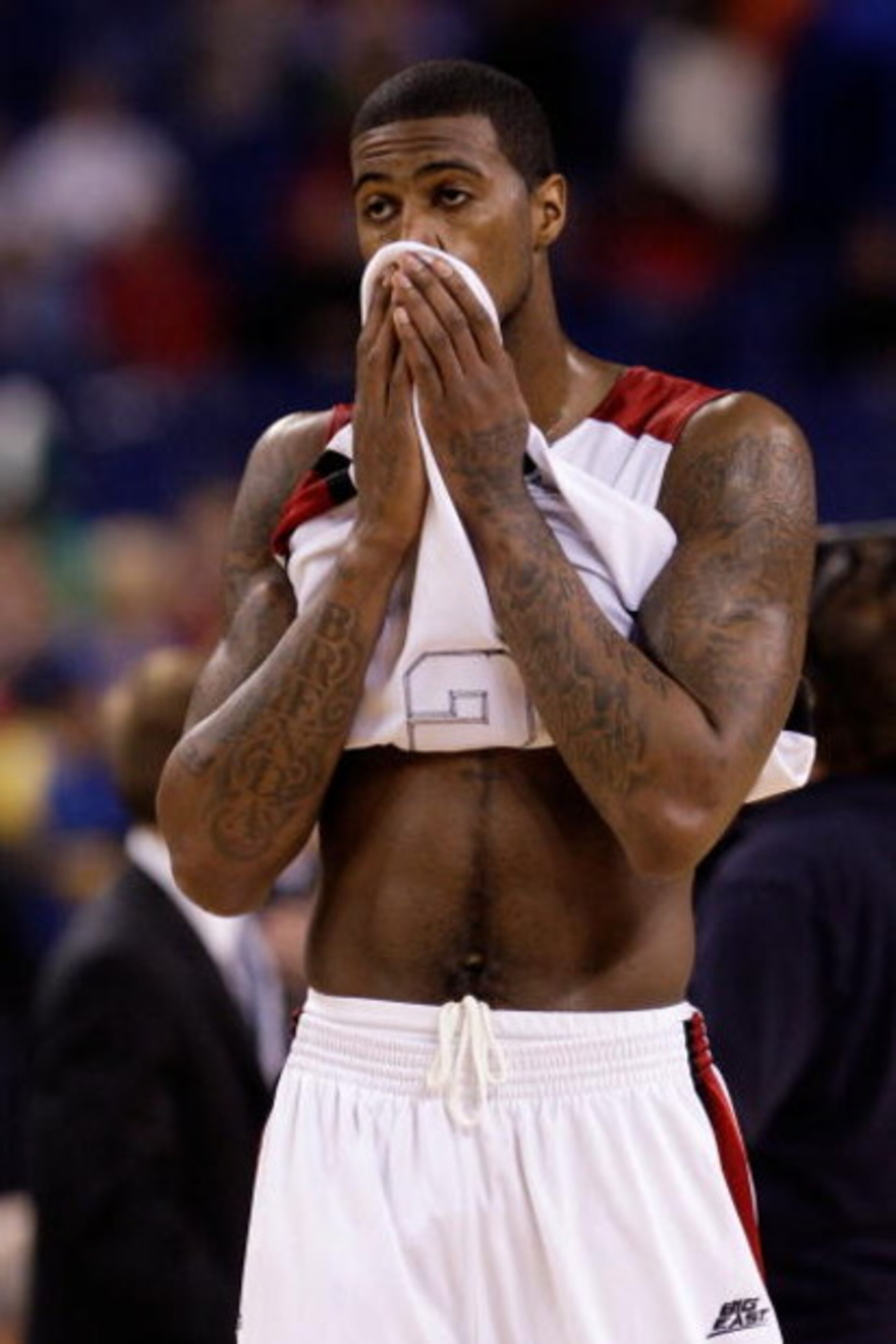 INDIANAPOLIS - MARCH 29:  Earl Clark #5 of the Louisville Cardinals covers his face with his jersey in the final minute of their 64-52 loss against the Michigan State Spartans during the fourth round of the NCAA Division I Men's Basketball Tournament at t