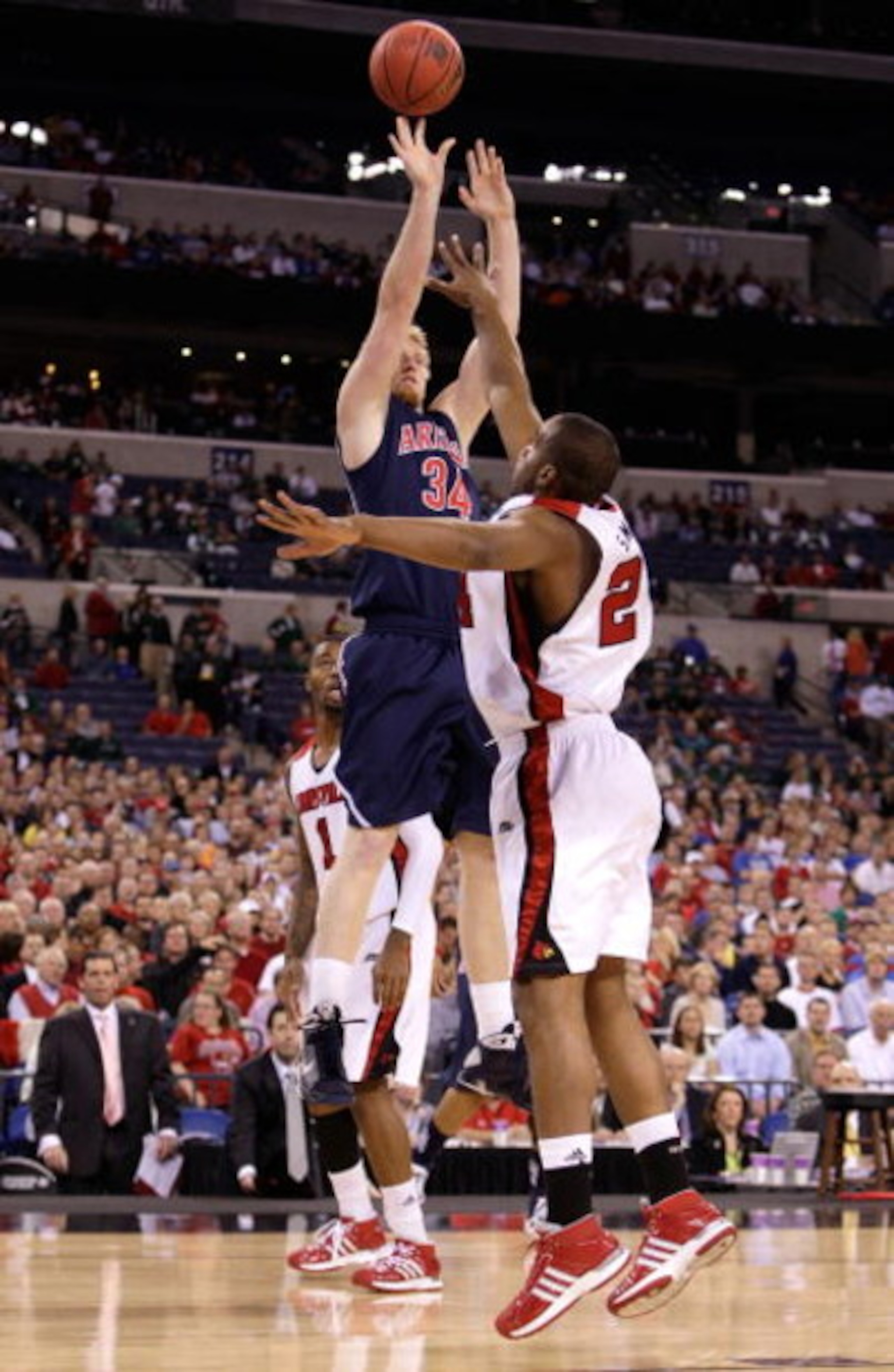 INDIANAPOLIS - MARCH 27:  Chase Budinger #34 of the Arizona Wildcats attempts a shot against Samardo Samuels #24 of the Louisville Cardinals during the third round of the NCAA Division I Men's Basketball Tournament at the Lucas Oil Stadium on March 27, 20