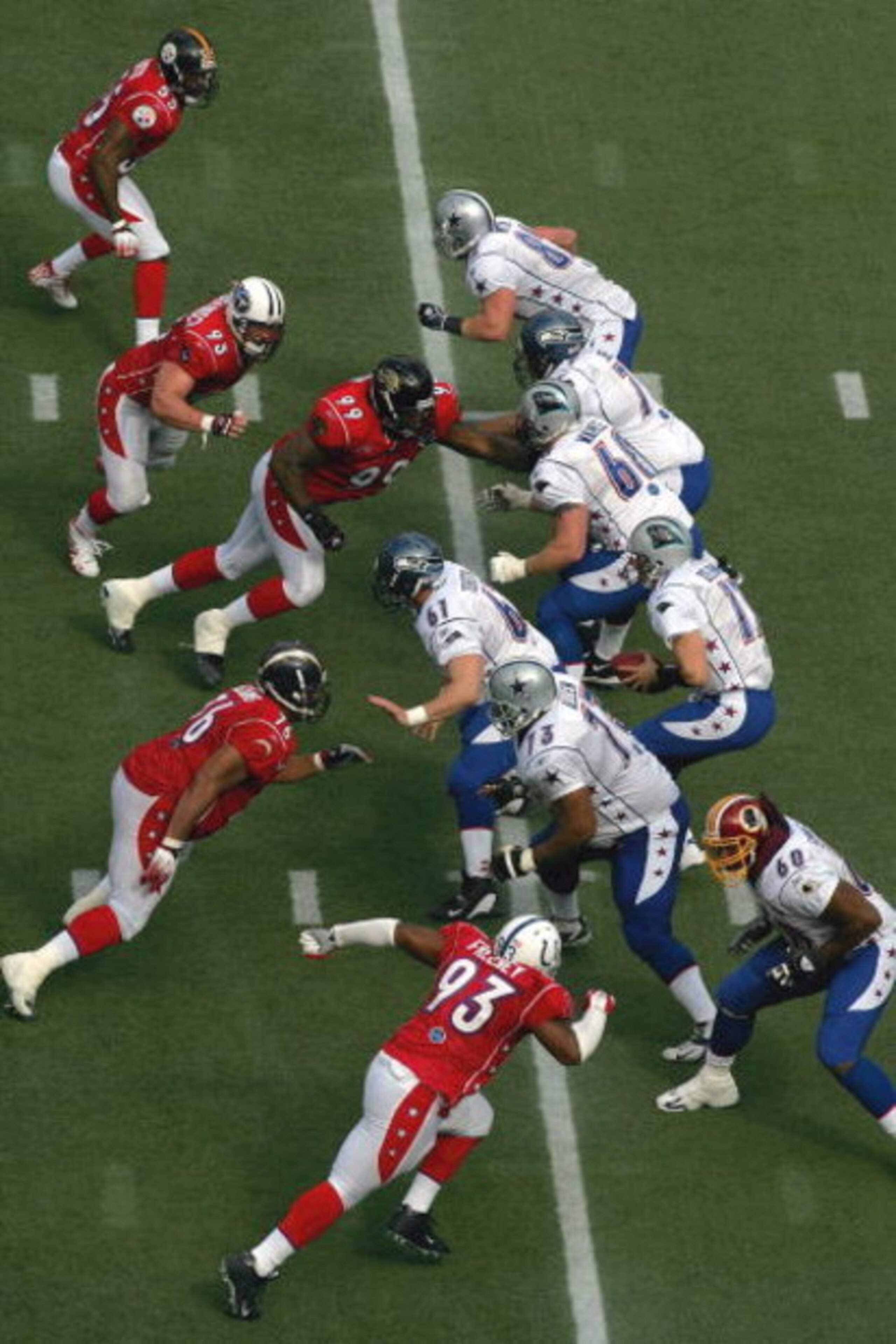 HONOLULU - FEBRUARY 12:  Quarterback Jake Delhomme #17 (R) of the NFC team drops back to pass against the AFC team during the NFL Pro Bowl on February 12, 2006 at Aloha Stadium in Honolulu, Hawaii. The NFC defeated the AFC 23-17.  (Photo by Ronald Martine