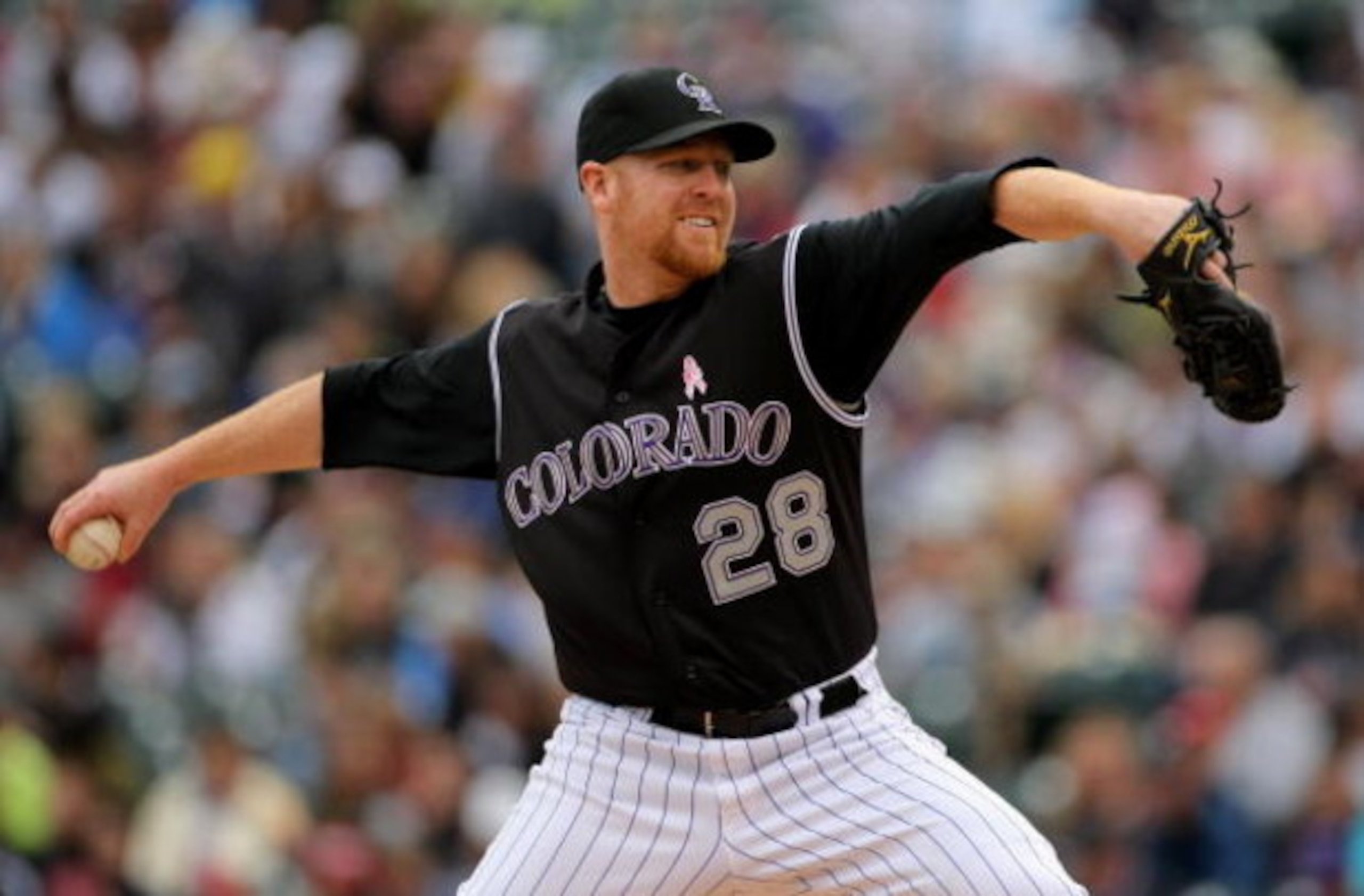 DENVER - MAY 10:  Starting pitcher Aaron Cook #28 of the Colorado Rockies delivers against  the Florida Marlins during MLB action at Coors Field on May 10, 2009 in Denver, Colorado. Cook earned the win as the Rockies defeated the Marlins 3-2.  (Photo by D
