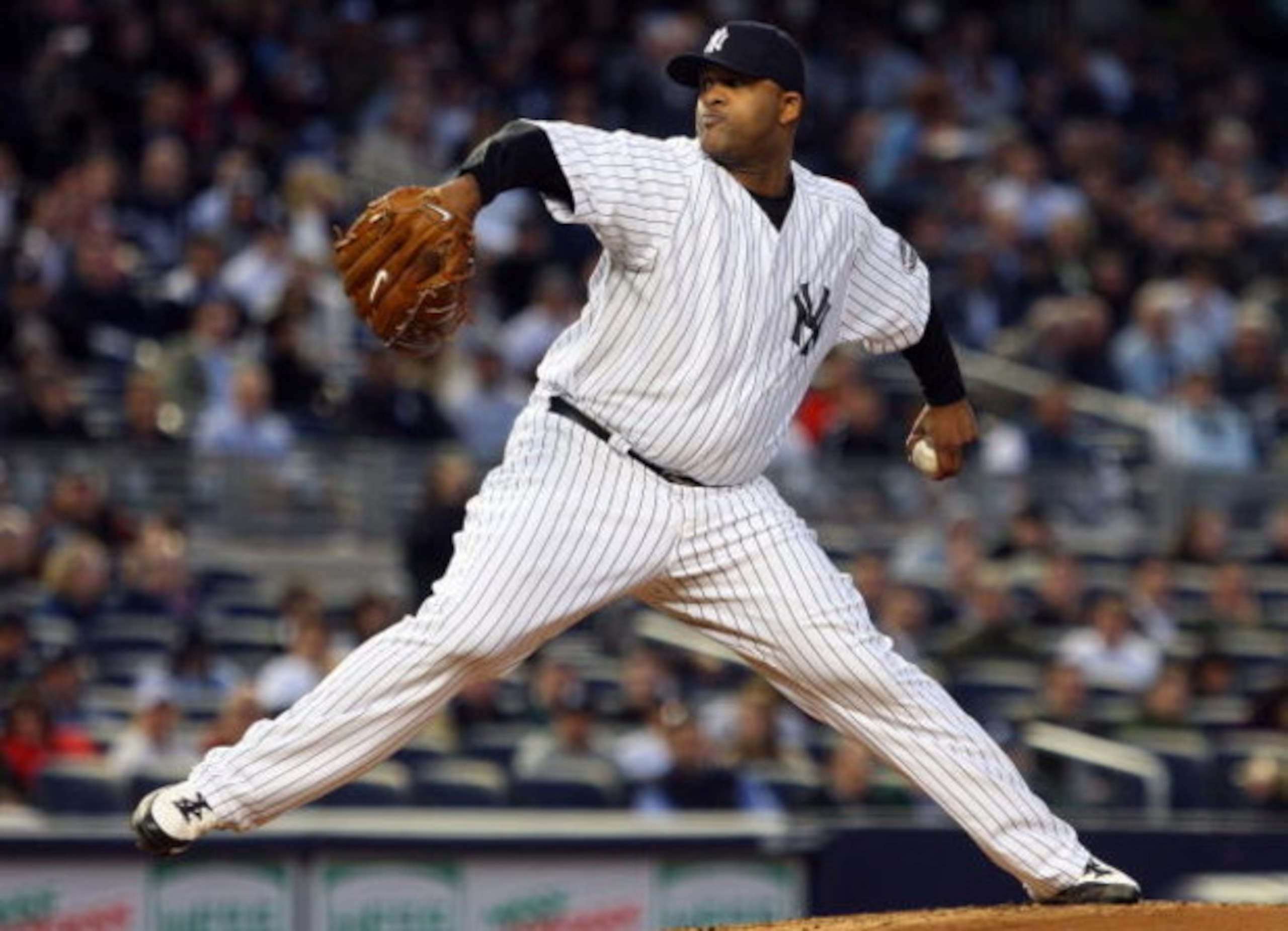 NEW YORK - MAY 19:  CC Sabathia #52 of the New York Yankees pitches against the Baltimore Orioles at Yankee Stadium May 19, 2009 in the Bronx borough of New York City.  (Photo by Jim McIsaac/Getty Images)