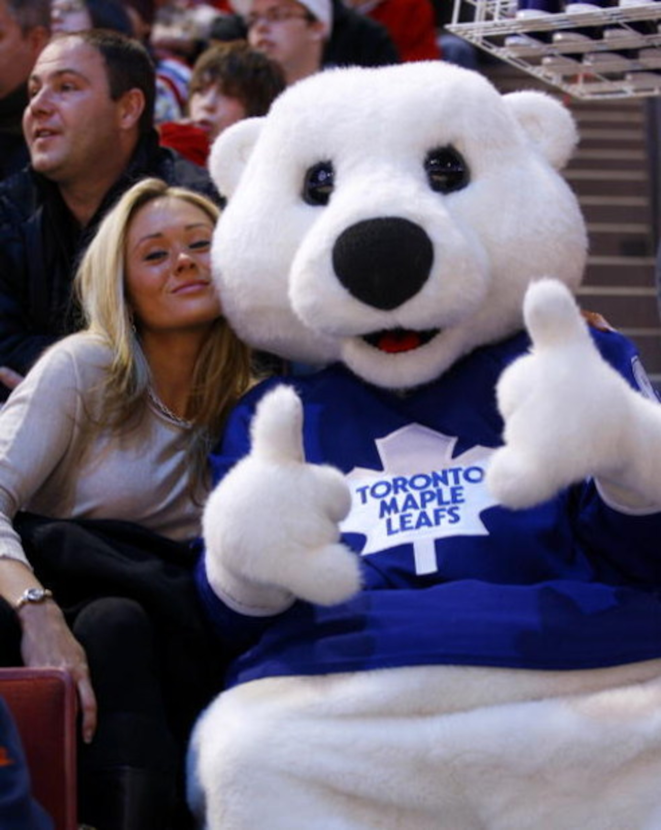 MONTREAL - JANUARY 24:  Carlton the Bear, the mascot of the Toronto Maple Leafs, hams it up with a fan at the Honda / NHL SuperSkills at Bell Center as part of the 2009 NHL All-Star Weekend festivities on January 24, 2009 in Montreal, Canada.  (Photo by P