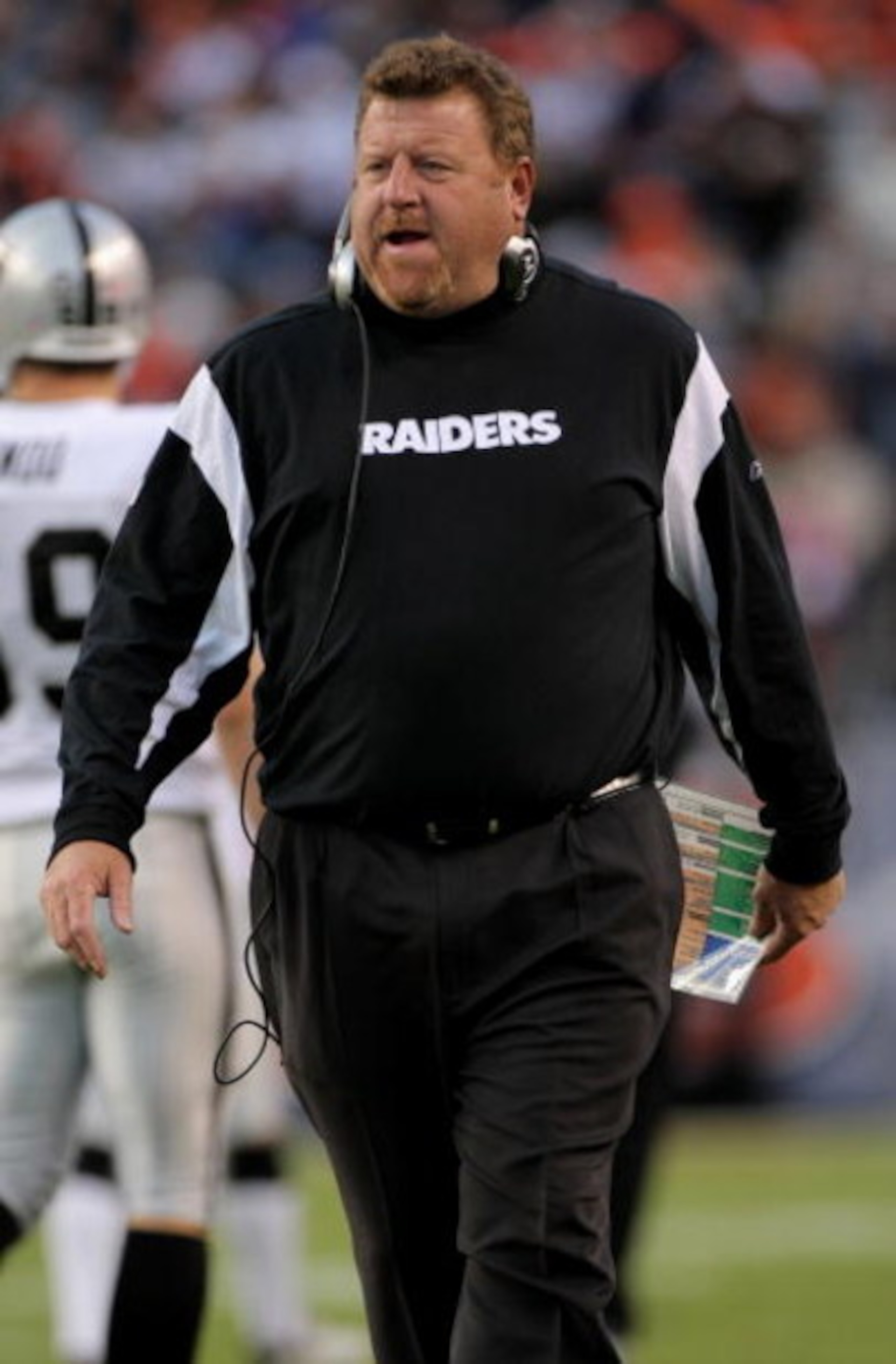 DENVER - NOVEMBER 23:  Head coach Tom Cable of the Oakland Raiders leads his team against the Denver Broncos during week 12 NFL action at Invesco Field at Mile High on November 23, 2008 in Denver, Colorado. The Raiders defeated the Broncos 31-10.  (Photo 