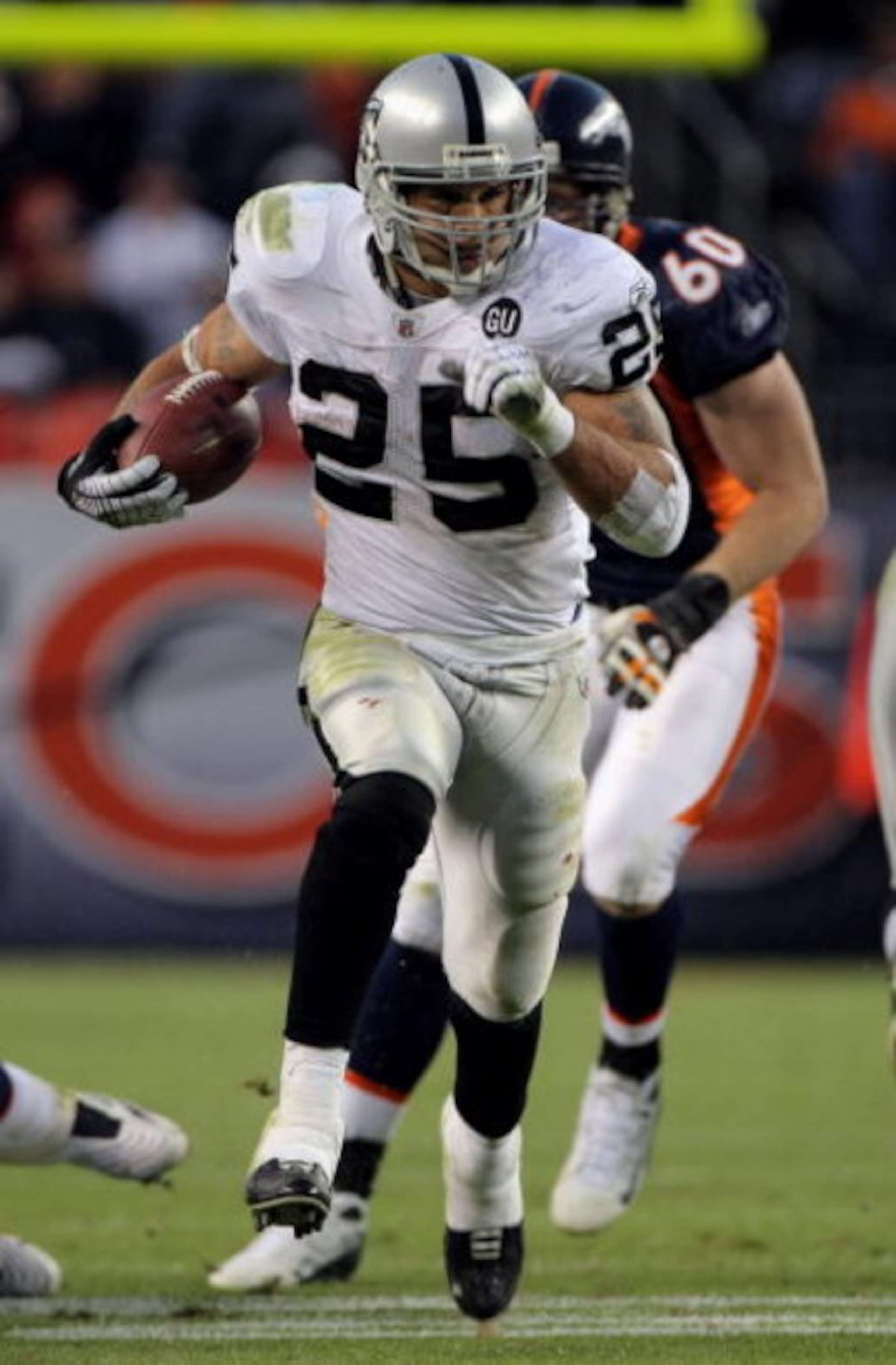 DENVER - NOVEMBER 23:  Running back Justin Fargas #25 of the Oakland Raiders carries the ball against the Denver Broncos during week 12 NFL action at Invesco Field at Mile High on November 23, 2008 in Denver, Colorado. Fargas rushed for 107 yards as the R