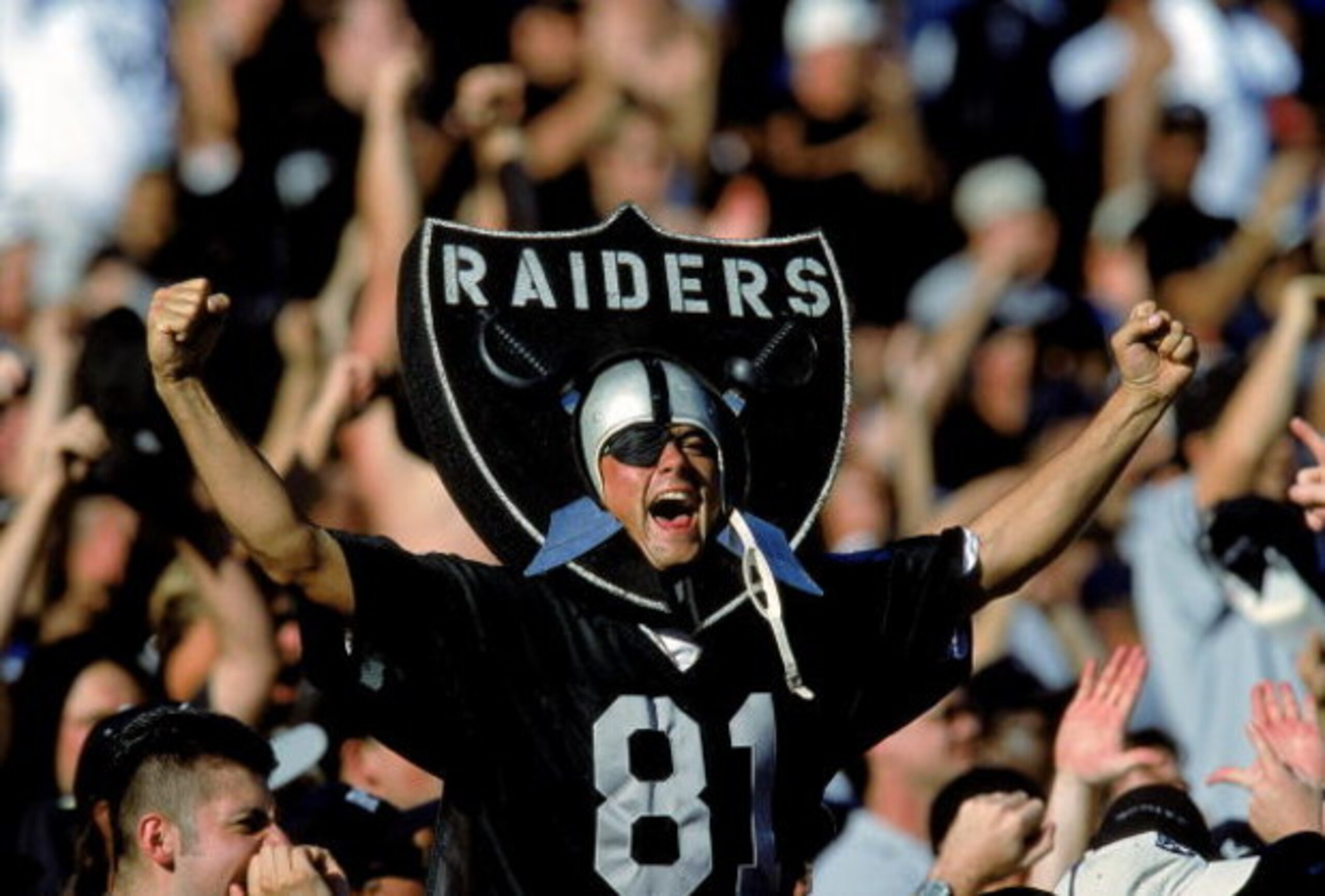 24 Oct 1999: A fan of the Oakland Raiders cheers in the stands as he wears the logo during a game against the New York Jets at the Network Coliseum in Oakland, California. The Raiders defeated the Jets 24-23. Mandatory Credit: Jon Ferrey  /Allsport