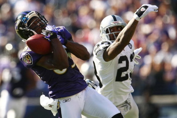 BALTIMORE - OCTOBER 26: Derrick Mason #85 of the Baltimore Ravens makes a catch under pressure from DeAngelo Hall #23 of the Oakland Raiders during the game at M&T Bank Stadium October 26, 2008 in Baltimore, Maryland.  (Photo by Chris McGrath/Getty Images
