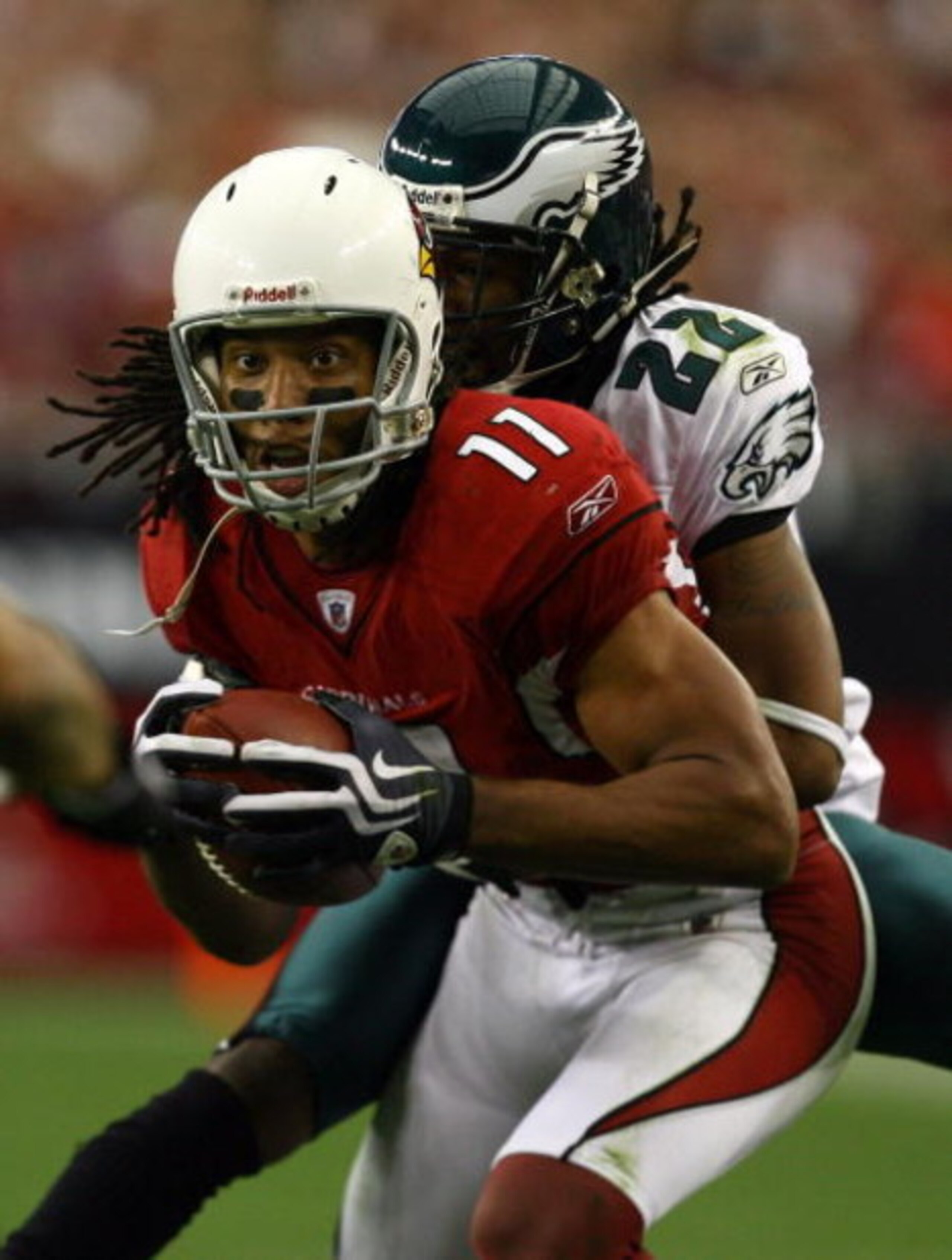 GLENDALE, AZ - JANUARY 18:  Wide receiver Larry Fitzgerald #11 of the Arizona Cardinals attempts to break a tackle by cornerback Asante Samuel #22 of the Philadelphia Eagles during the NFC championship game on January 18, 2009 at University of Phoenix Sta