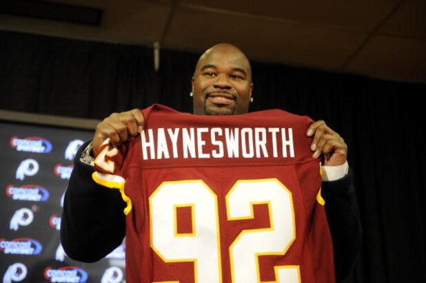 ASHBURN, VA - FEBRUARY 27:  Albert Haynesworth posese with his new jersey at a press conference after signing a 7-year contract worth approximately $100 million with the Washington Redskins on February 27, 2009 at Redskins Park in Ashburn, Virginia.  (Pho