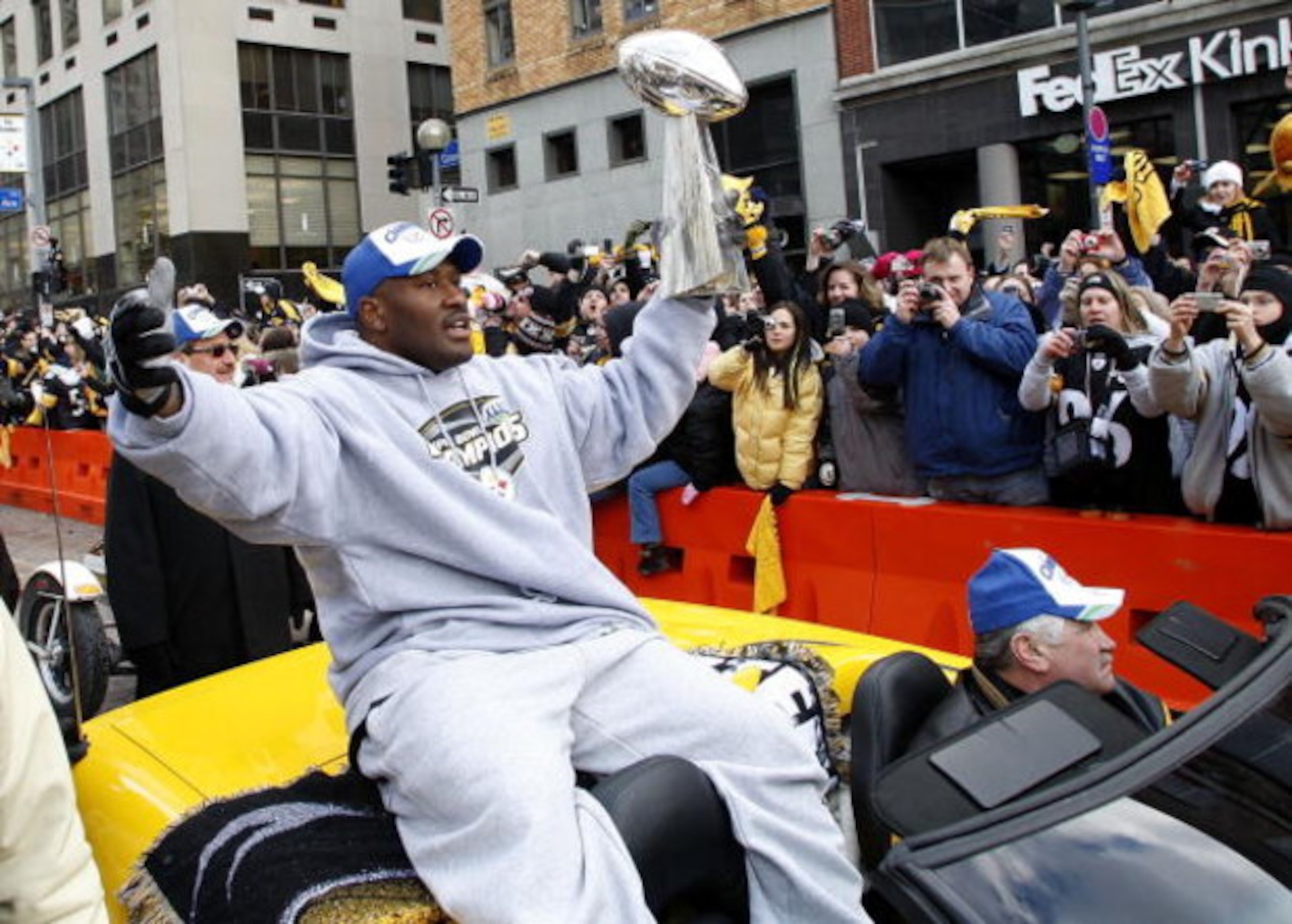 PITTSBURGH - FEBRUARY 03:  James Harrison #92 of the Pittsburgh Steelers shows off the Super Bowl XLIII trophy during a parade on February 3, 2009 in Pittsburgh, Pennsylvania.  (Photo by Gregory Shamus/Getty Images)