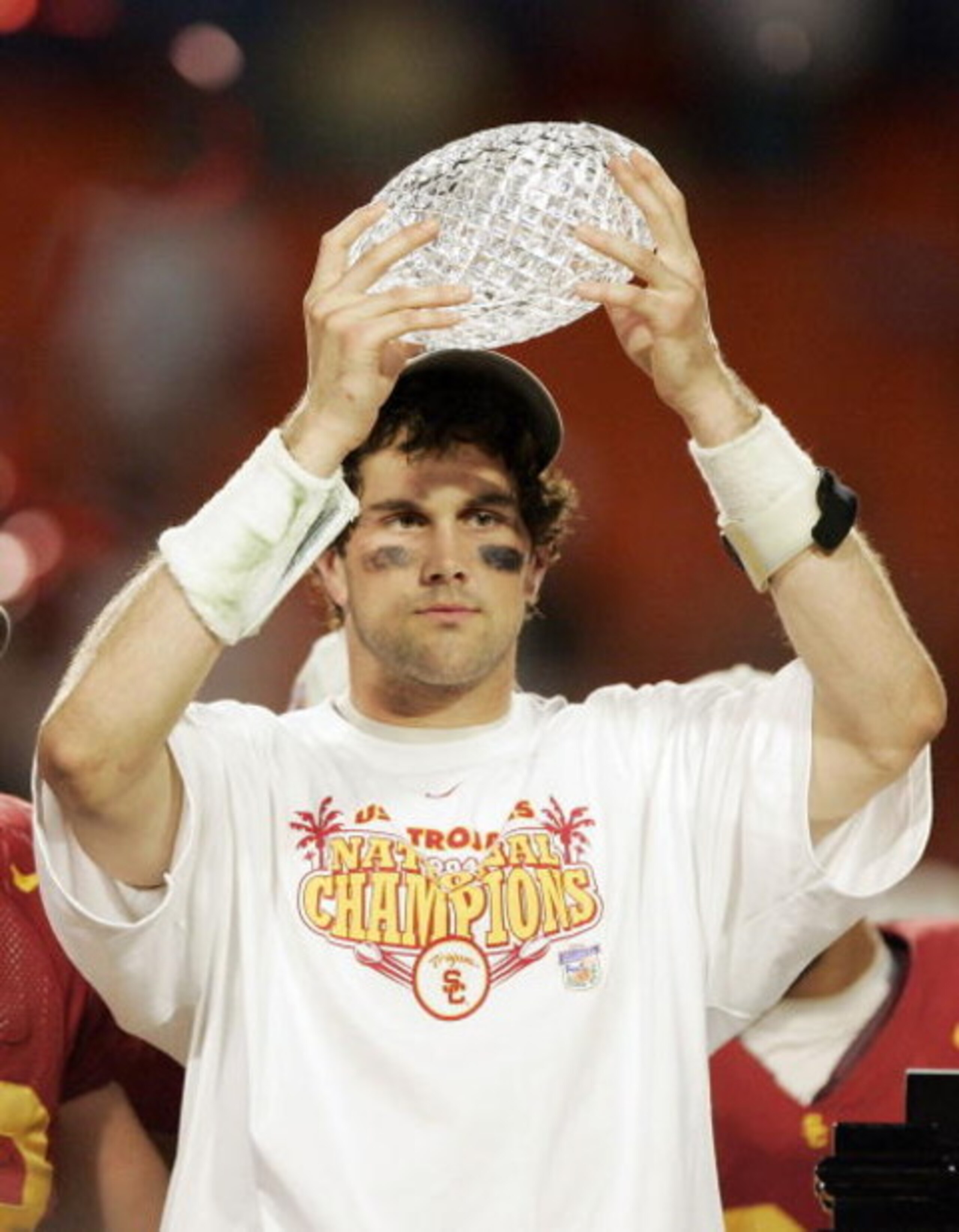 MIAMI - JANUARY 4:  Quarterback Matt Leinart #11 of the USC Trojans holds up the championship trophy after defeating the Oklahoma Sooners 55-19 to win the FedEx Orange Bowl 2005 National Championship on January 4, 2005 at Pro Player Stadium in Miami, Flor