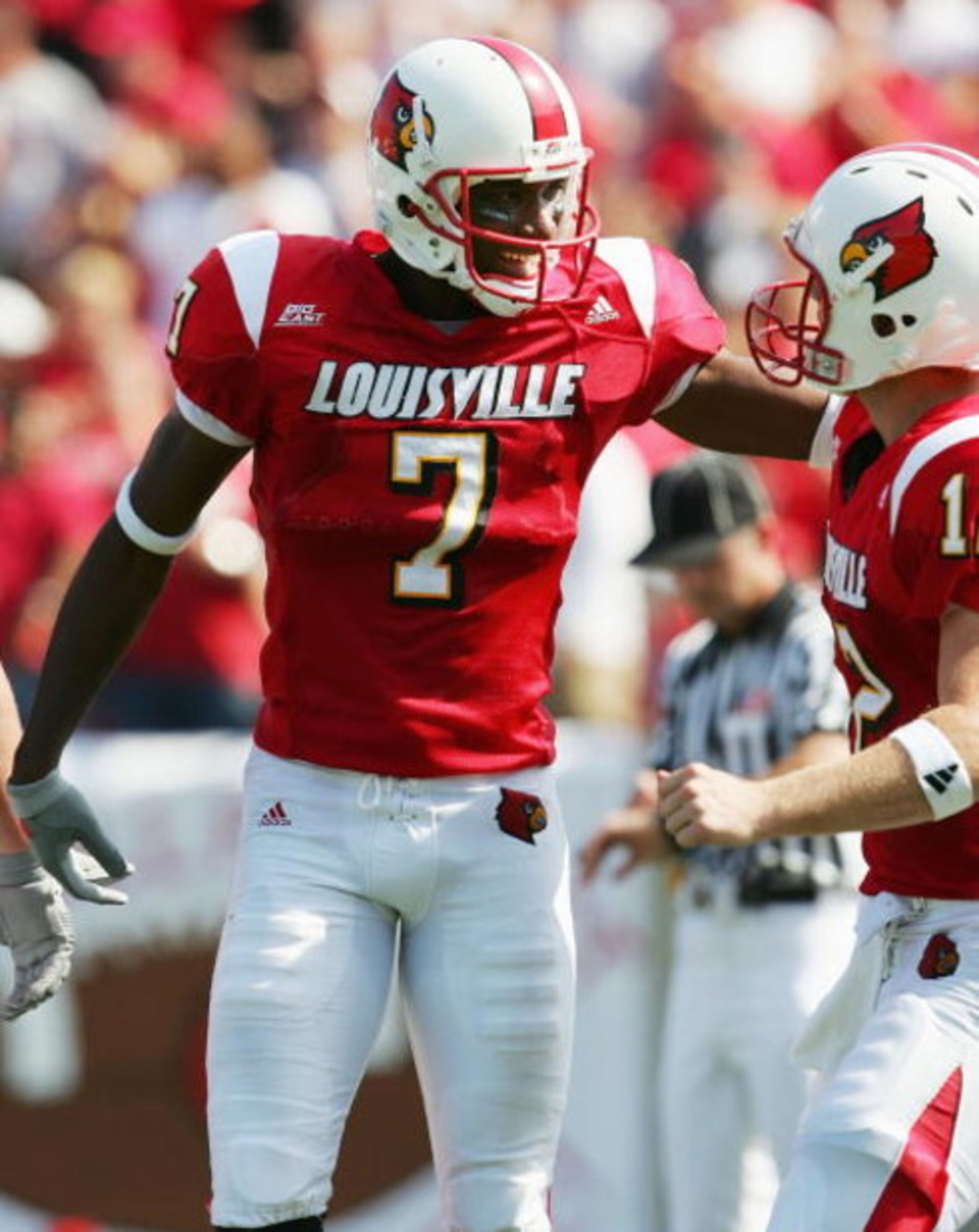 LOUISVILLE, KY - OCTOBER 1:  Mario Urrutia #7 of the Louisville Cardinals is congratulated by Brian Brohn #12 after scoring a touchdown against the Florida Atlantic Owls during the game at Papa John's Stadium on October 1, 2005 in Louisville, Kentucky.   