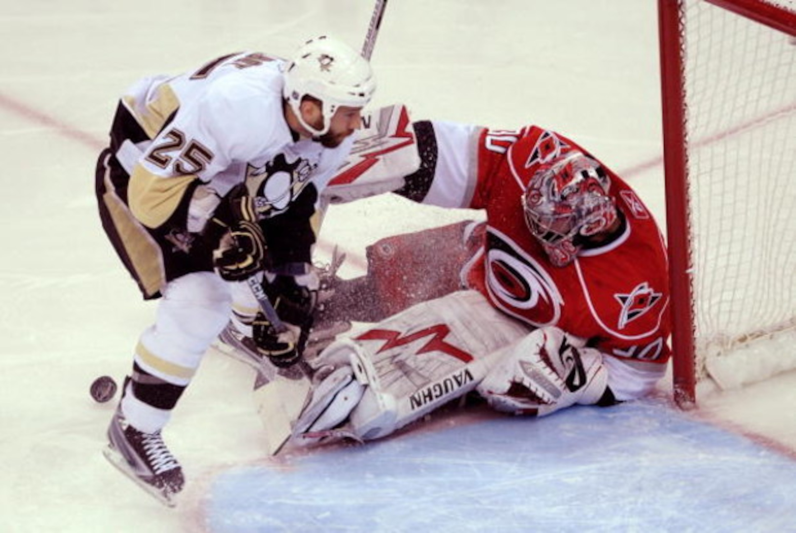 RALEIGH, NC - MAY 23:  Maxime Talbot #25 of the Pittsburgh Penguins attacks as goaltender Cam Ward #30 of the Carolina Hurricanes saves a shot on goal during Game Three of the Eastern Conference Championship Round of the 2009 Stanley Cup Playoffs at RBC C