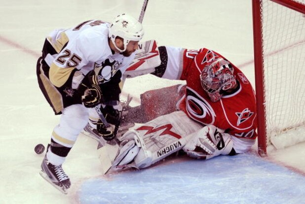 RALEIGH, NC - MAY 23:  Maxime Talbot #25 of the Pittsburgh Penguins attacks as goaltender Cam Ward #30 of the Carolina Hurricanes saves a shot on goal during Game Three of the Eastern Conference Championship Round of the 2009 Stanley Cup Playoffs at RBC C