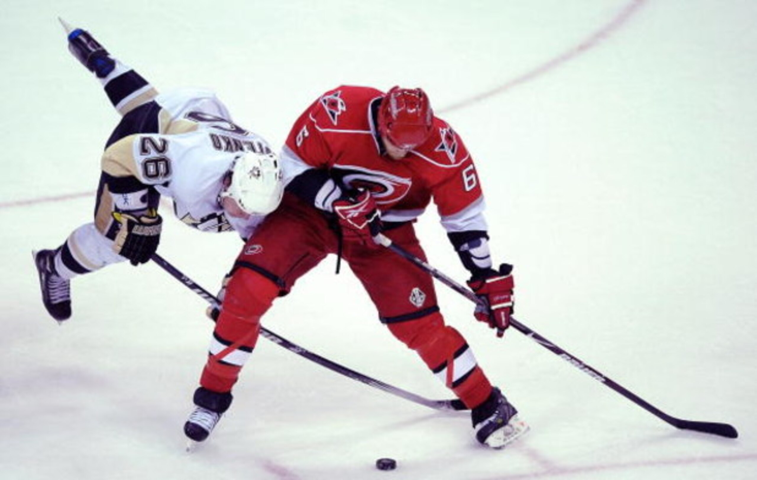 RALEIGH, NC - MAY 23:  Ruslan Fedotenko #26 of the Pittsburgh Penguins battles for the puck against Tim Gleason during Game Three of the Eastern Conference Championship Round of the 2009 Stanley Cup Playoffs at RBC Center on May 23, 2009 in Raleigh, North