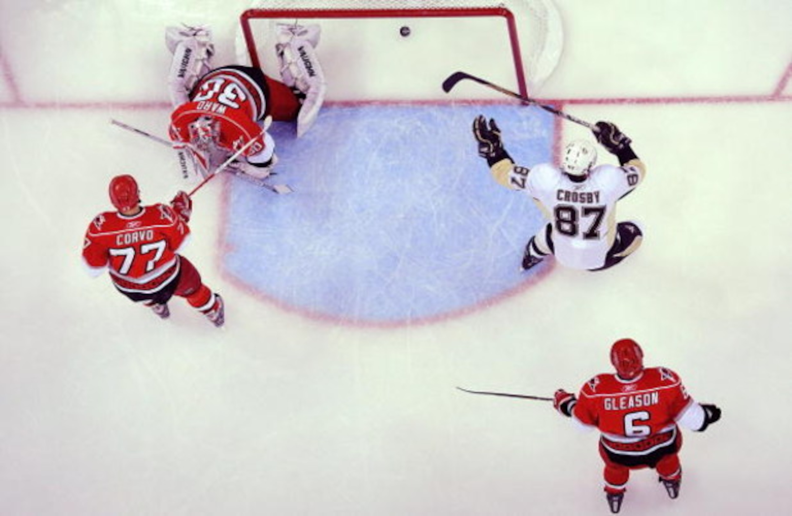 RALEIGH, NC - MAY 23:  Sidney Crosby #87 of the Pittsburgh Penguins scores a goal past goaltender Cam Ward #30, Joe Corvo #77 and Tim Gleason #6 of the Carolina Hurricanes during Game Three of the Eastern Conference Championship Round of the 2009 Stanley 