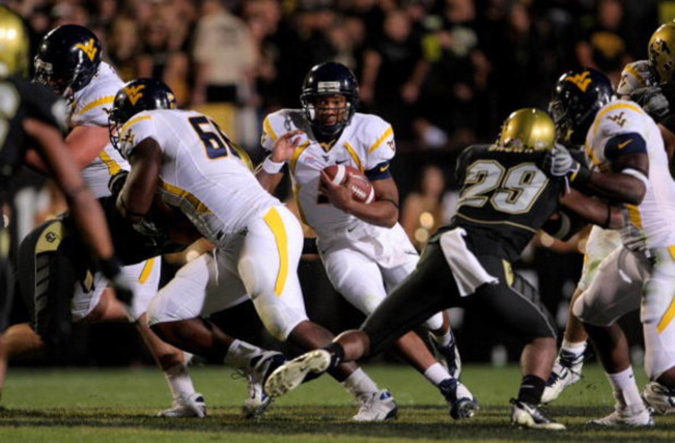 BOULDER, CO - SEPTEMBER 18:  Quarterback Pat White #5 of the West Virginia Mountaineers rushes against the Colorado Buffaloes at Folsom Field September 18, 2008 in Boulder, Colorado. Colorado defeated West Virginia 17-14 in overtime.  (Photo by Doug Pensi