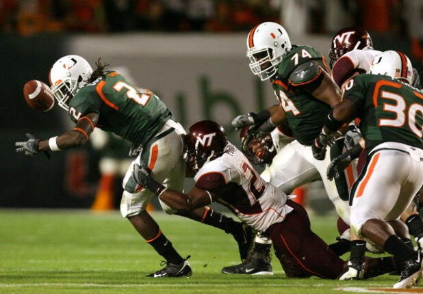 MIAMI - NOVEMBER 13:  Dorian Porch #24 of the Virginia Tech Hokies causes a fumble by running back Craig Cooper #2 of the Miami Hurricanes at Dolphin Stadium on November 13, 2008 in Miami, Florida. Miami defeated Virginia Tech 16-14.  (Photo by Doug Benc/