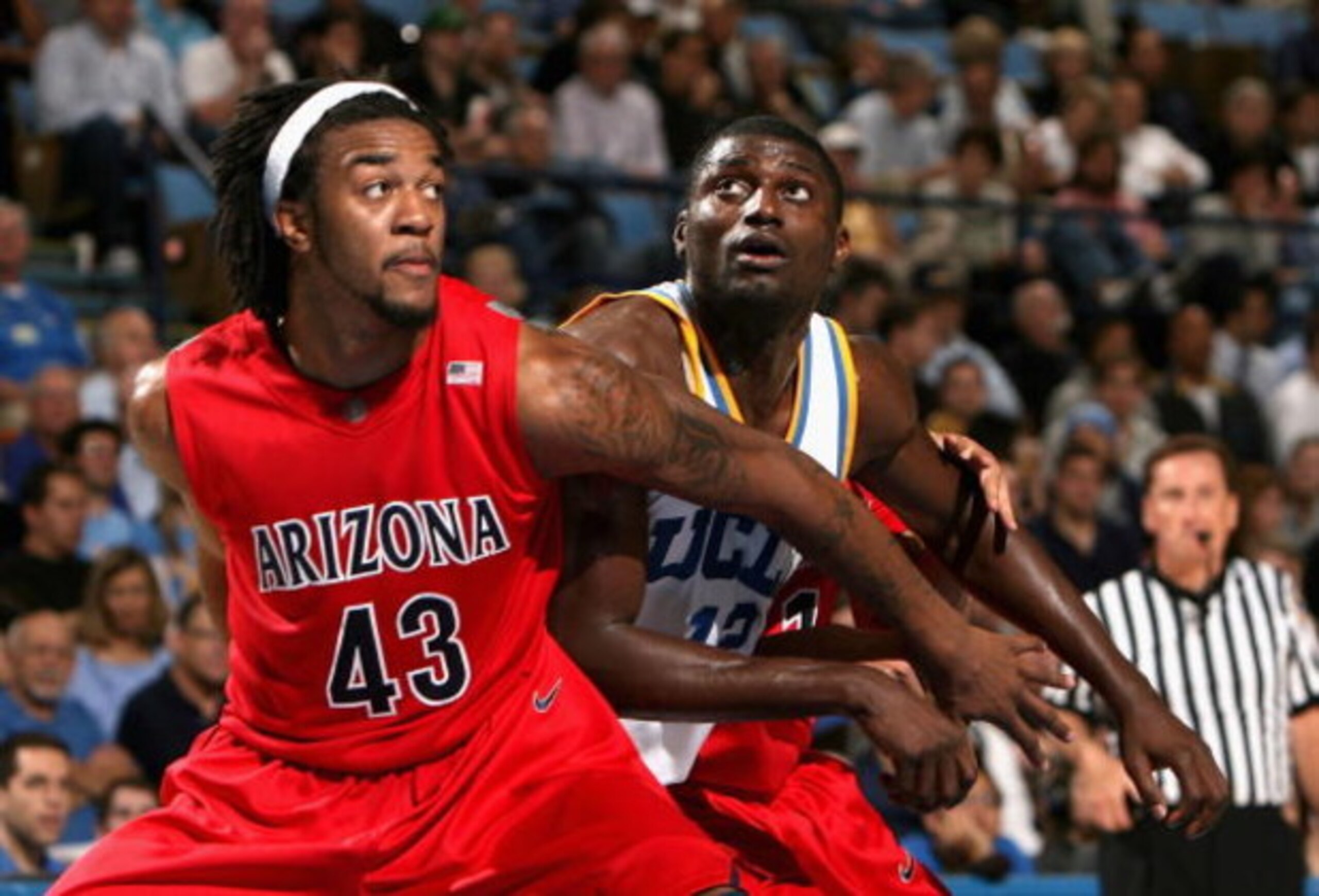 WESTWOOD, CA - JANUARY 15:  Alfred Aboya #12 of the UCLA Bruins battles for position with  Jordan Hill #43 of the Arizona Wildcats during the college basketball game at Pauley Pavilion on January 15, 2009 in Westwood, California. The Bruins defeated the W
