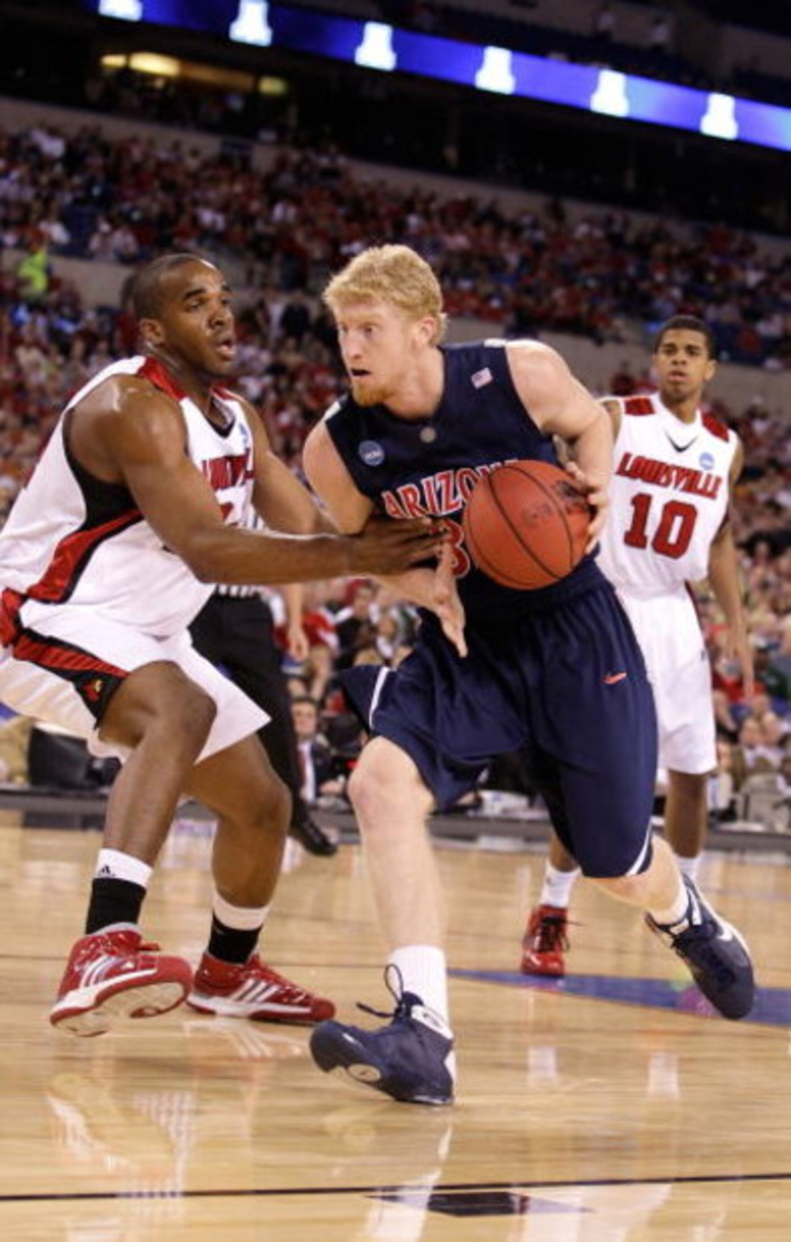 INDIANAPOLIS - MARCH 27:  Chase Budinger #34 of the Arizona Wildcats drives against the Louisville Cardinals  during the third round of the NCAA Division I Men's Basketball Tournament at the Lucas Oil Stadium on March 27, 2009 in Indianapolis, Indiana. Lo