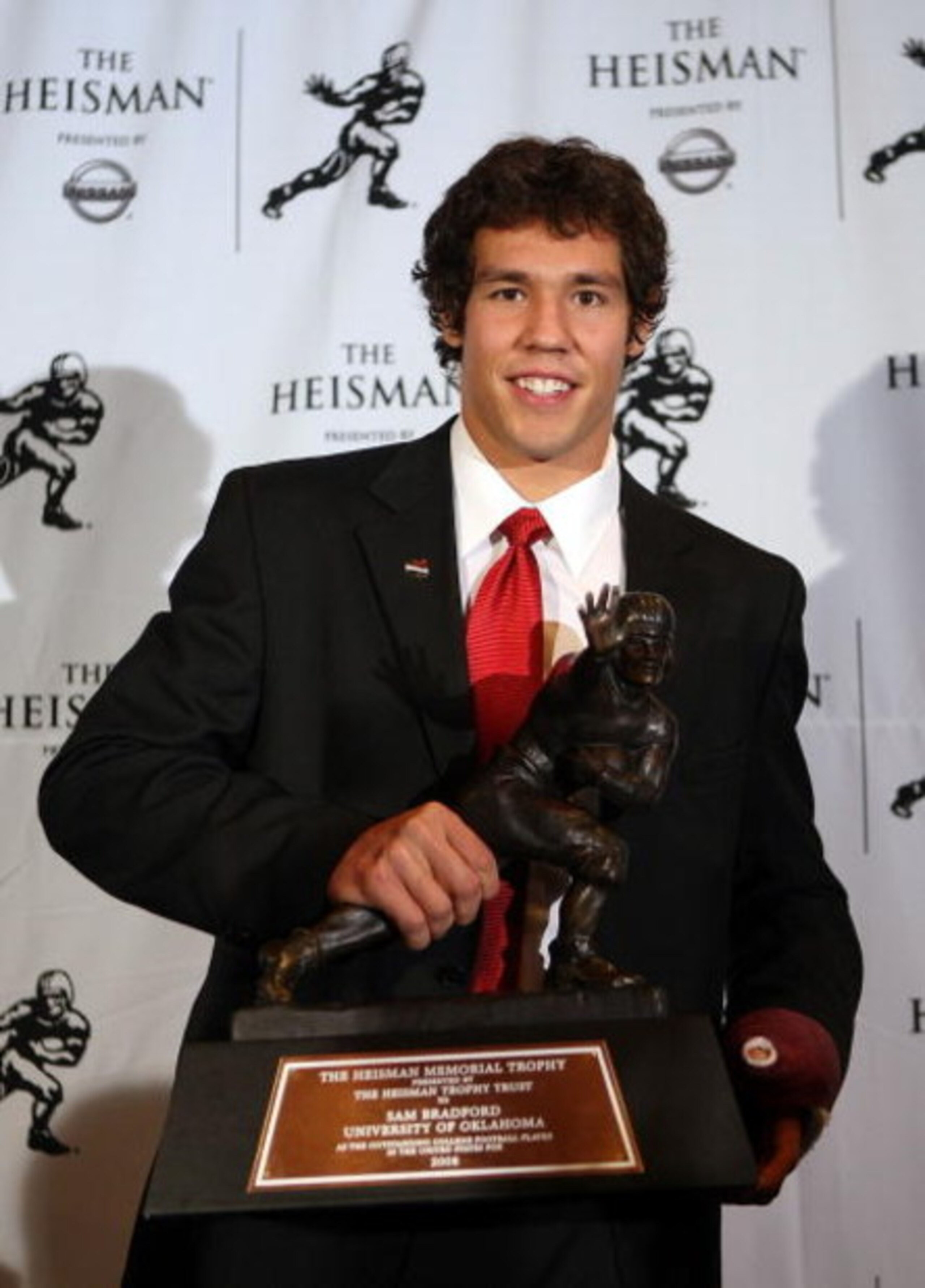 NEW YORK - DECEMBER 13:  Sam Bradford of the Oklahoma Sooners holds the Heisman Trophy on December 13, 2008 at the Sports Museum of America in New York City.  (Photo by Nick Laham/Getty Images)