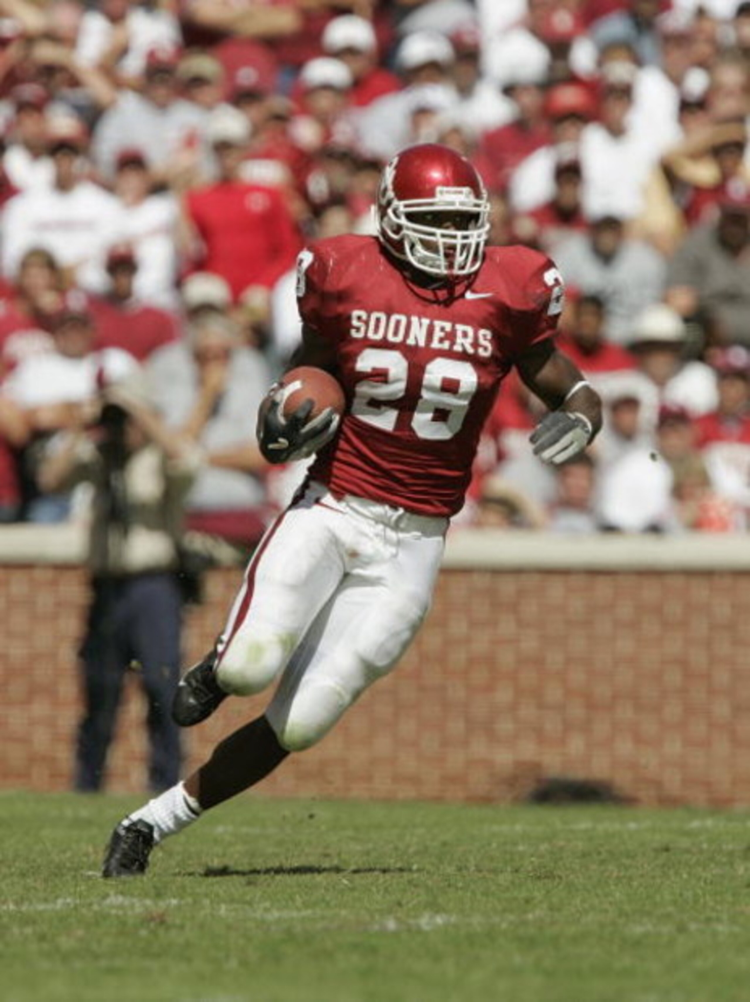 NORMAN, OK - OCTOBER 2:  Running back Adrian Peterson #28 of the Oklahoma Sooners runs upfield against the Texas Tech Red Raiders on October 2, 2004 at Memorial Stadium in Norman, Oklahoma.  The Sooners defeated the Red Raiders  28-13.  (Photo by Brian Ba