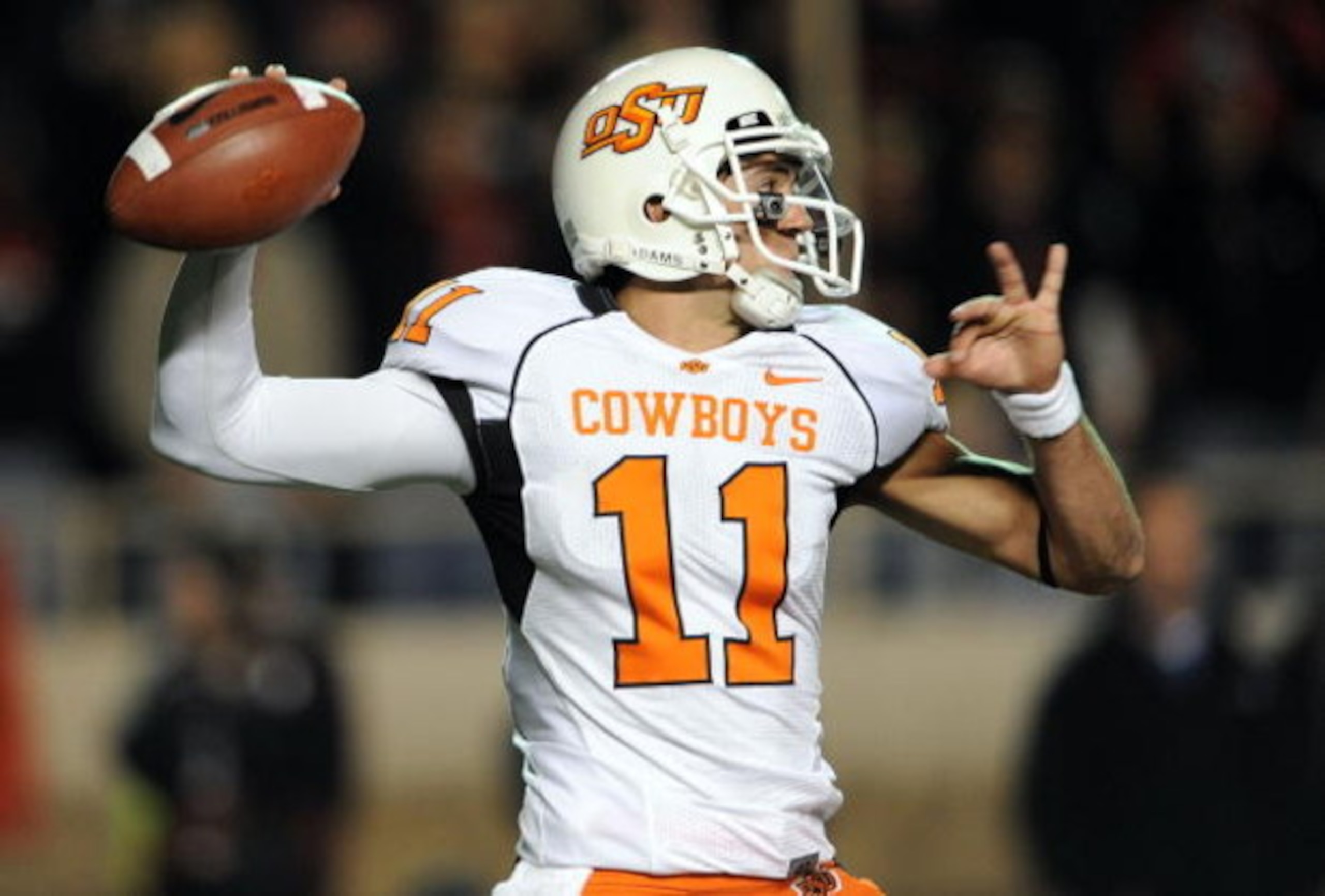 LUBBOCK, TX - NOVEMBER 08:  Quarterback Zac Robinson #11 of the Oklahoma State Cowboys drops back to pass against the Texas Tech Red Raiders at Jones AT&T Stadium on November 8, 2008 in Lubbock, Texas.  (Photo by Ronald Martinez/Getty Images)