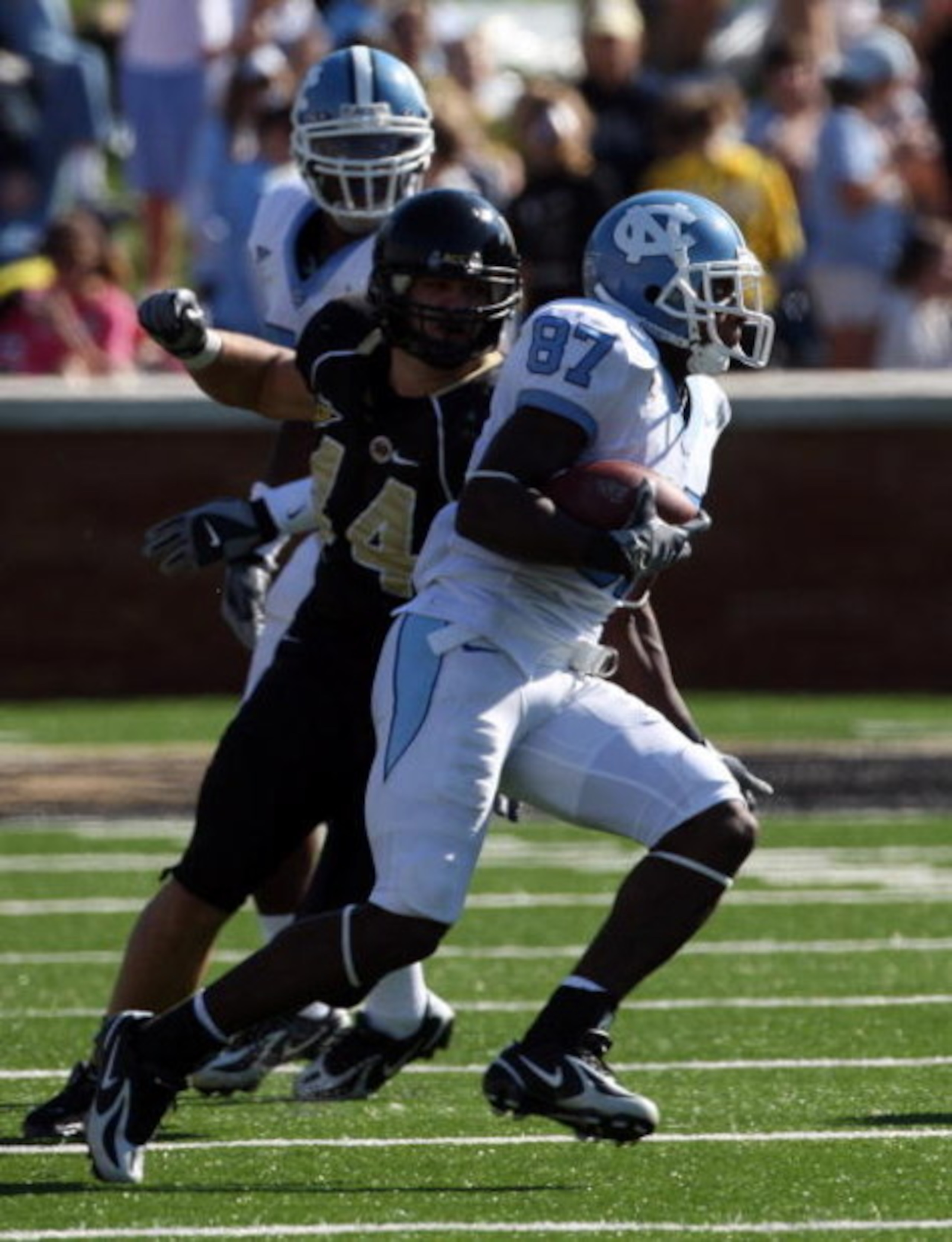 WINSTON SALEM, NC - OCTOBER 27:  Mike Rinfrette #44 the Linebacker of Wake Forest Demon Deacons tackles Brandon Tate #87 of the UNC Tar Heels during the ACC game at the Groves Stadium, on October 27, 2007 in Winston Salem,North Carolina.  (Photo by David 