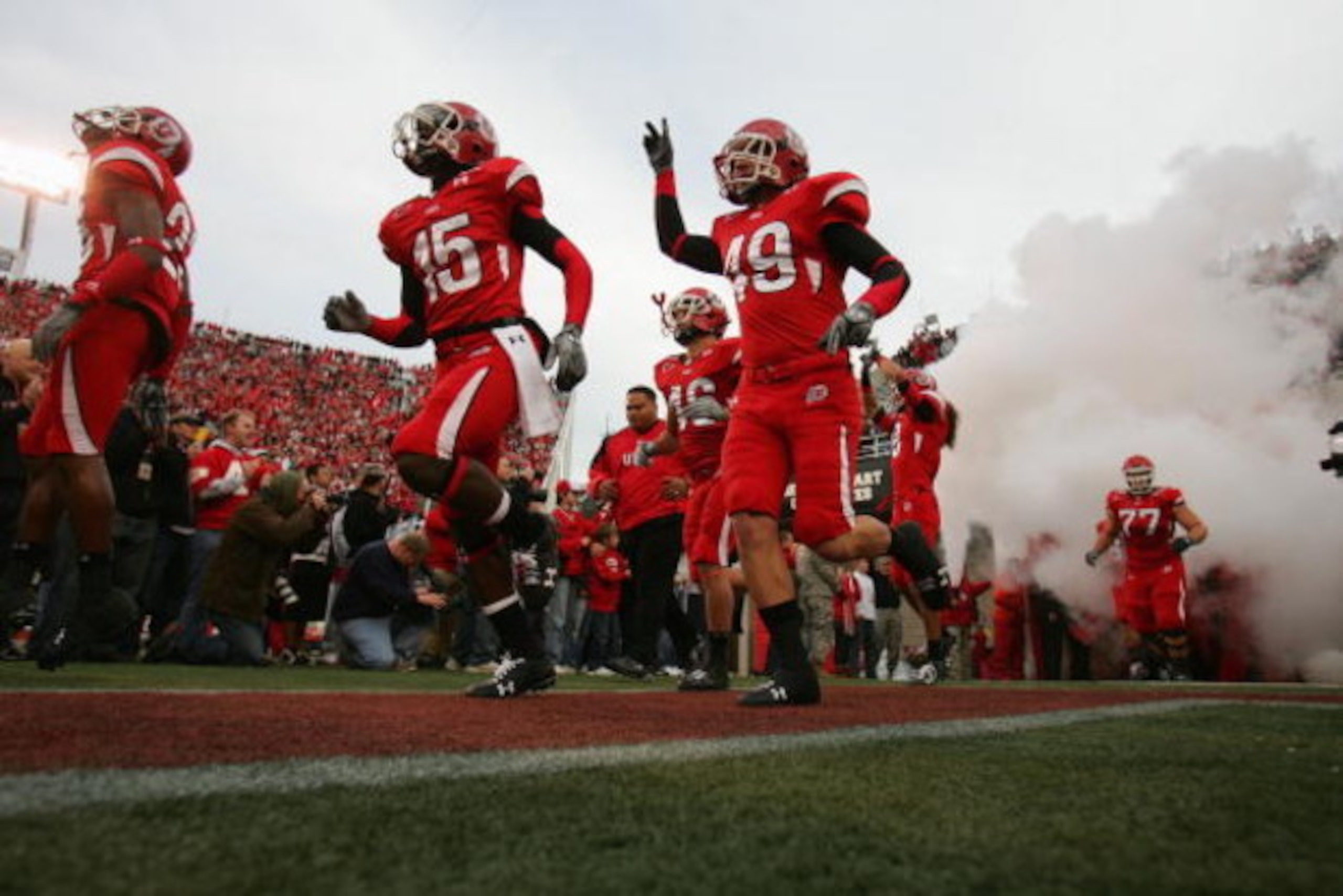 SALT LAKE CITY, UT - NOVEMBER 22:  DeVonte Christopher #15 and Greg Bird #49 of the Utah Utes run onto the field before the game against the BYU Cougars at Rice-Eccles Stadium on November 22, 2008 in Salt Lake City, Utah. (Photo by Jonathan Ferrey/Getty I