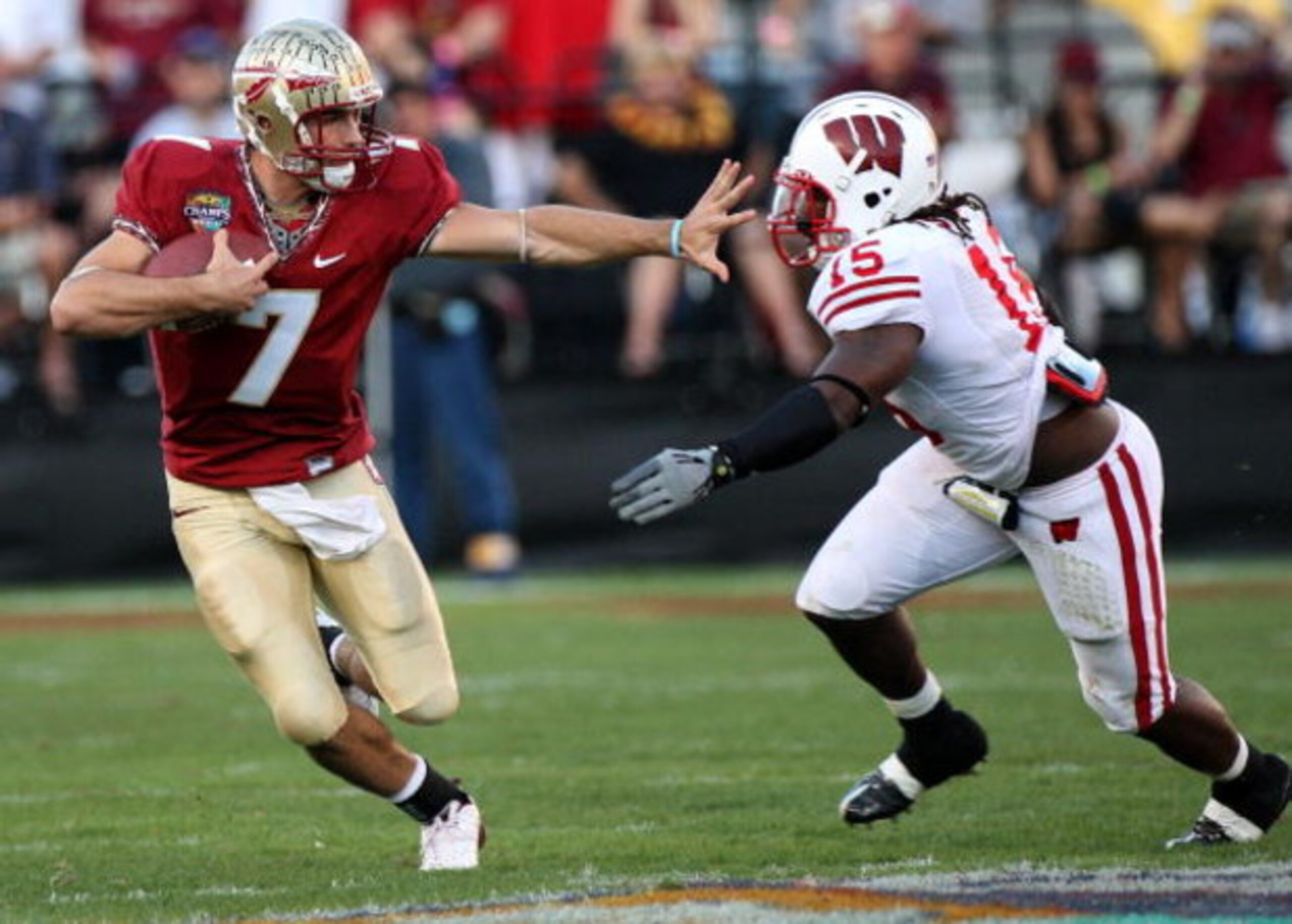 ORLANDO, FL - DECEMBER 27:  Christian Ponder #7 of the Florida State Seminoles attempts to avoid the tackle of Culmer St. Jean #15 of the Wisconsin Badgers during the Champs Bowl on December 27, 2008 at the Citrus Bowl in Orlando, Florida.  (Photo by Sam 
