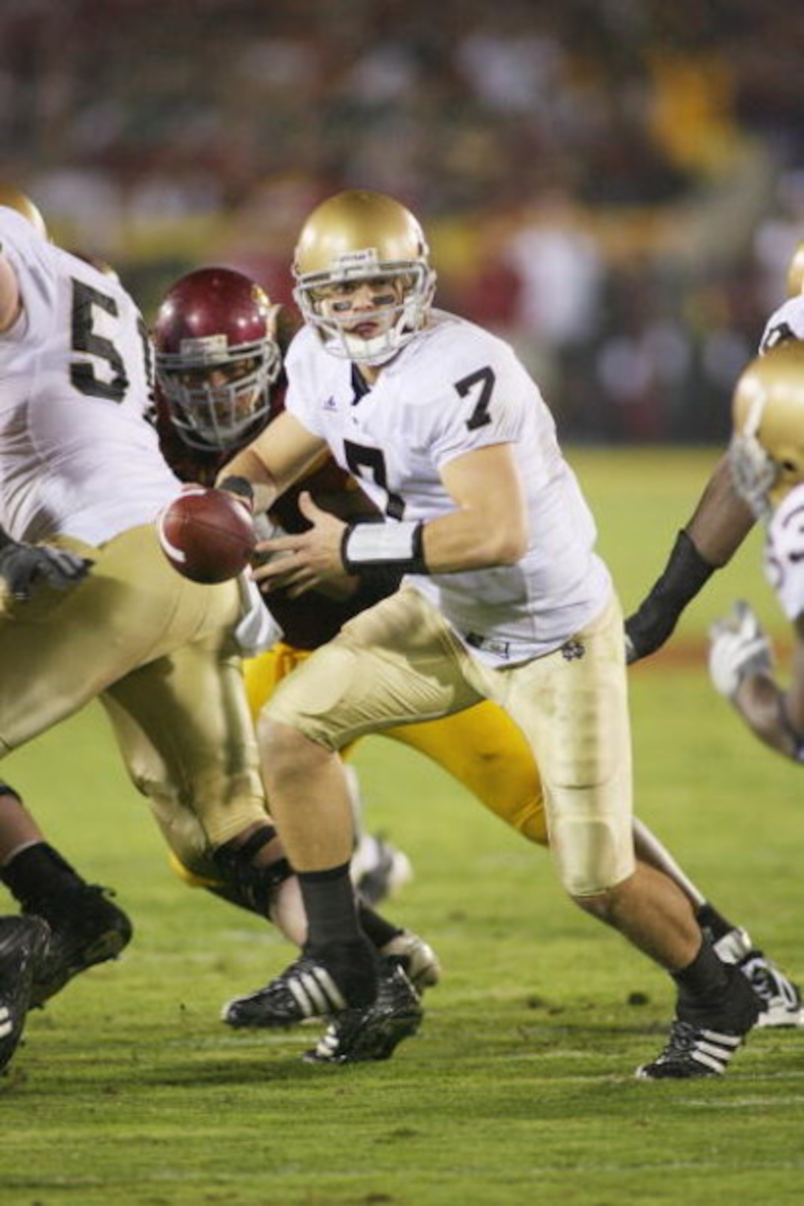 LOS ANGELES - NOVEMBER 29:  Jimmy Clausen #7 of the Notre Dame Fighting Irish looks to hand off the ball against the USC Trojans on November 29, 2008 at the Los Angeles Memorial Coliseum in Los Angeles, California.  USC won 38-3.  (Photo by Jeff Golden/Ge