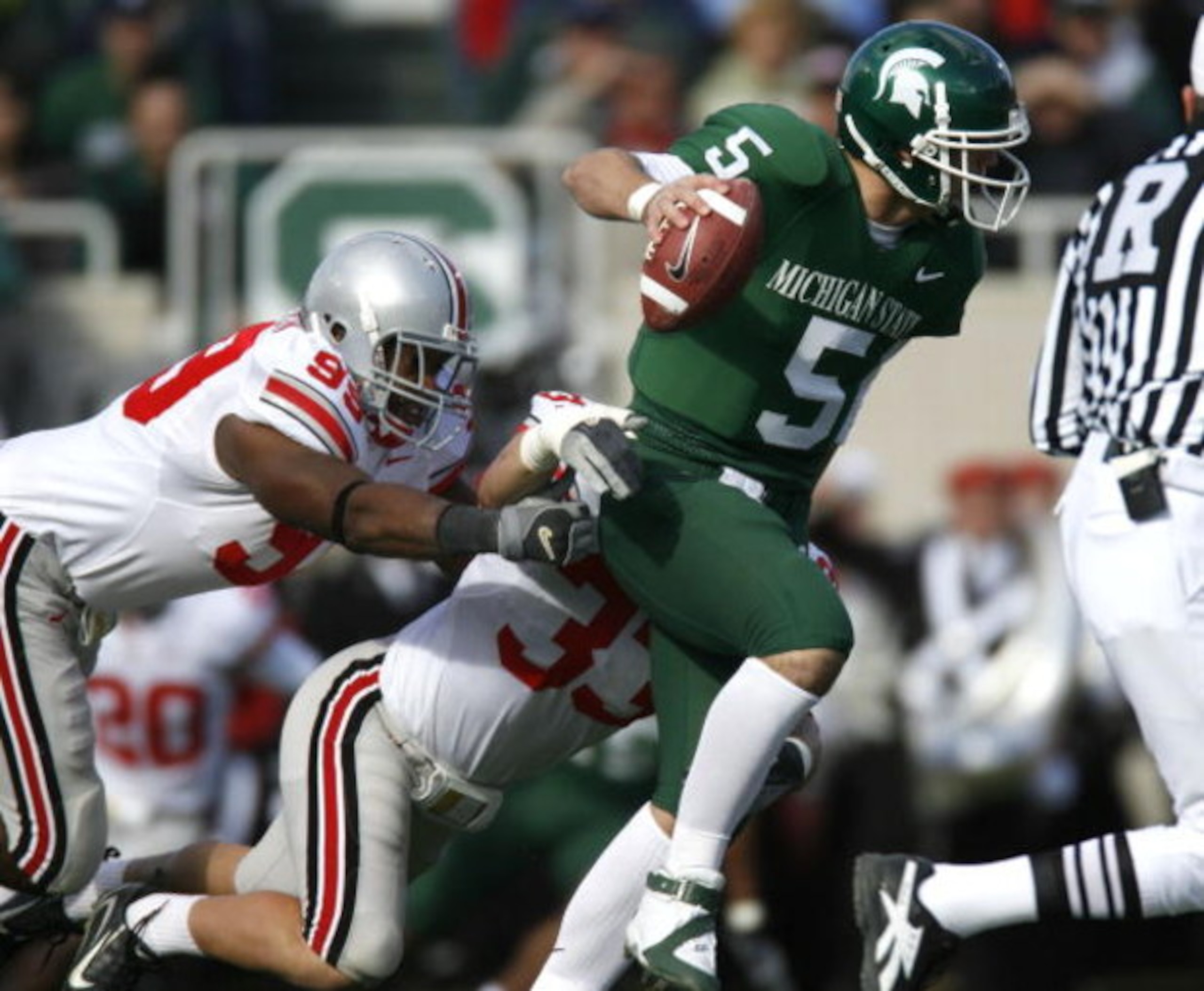EAST LANSING, MI - OCTOBER 14:  Drew Stanton #5 of the Michigan State Spartans tries to escape the tackle of Jay Richardson #99 and James Laurinaitis #33 of the Ohio State Buckeys during first quarter action on October 14, 2006 at Spartan Stadium in East 
