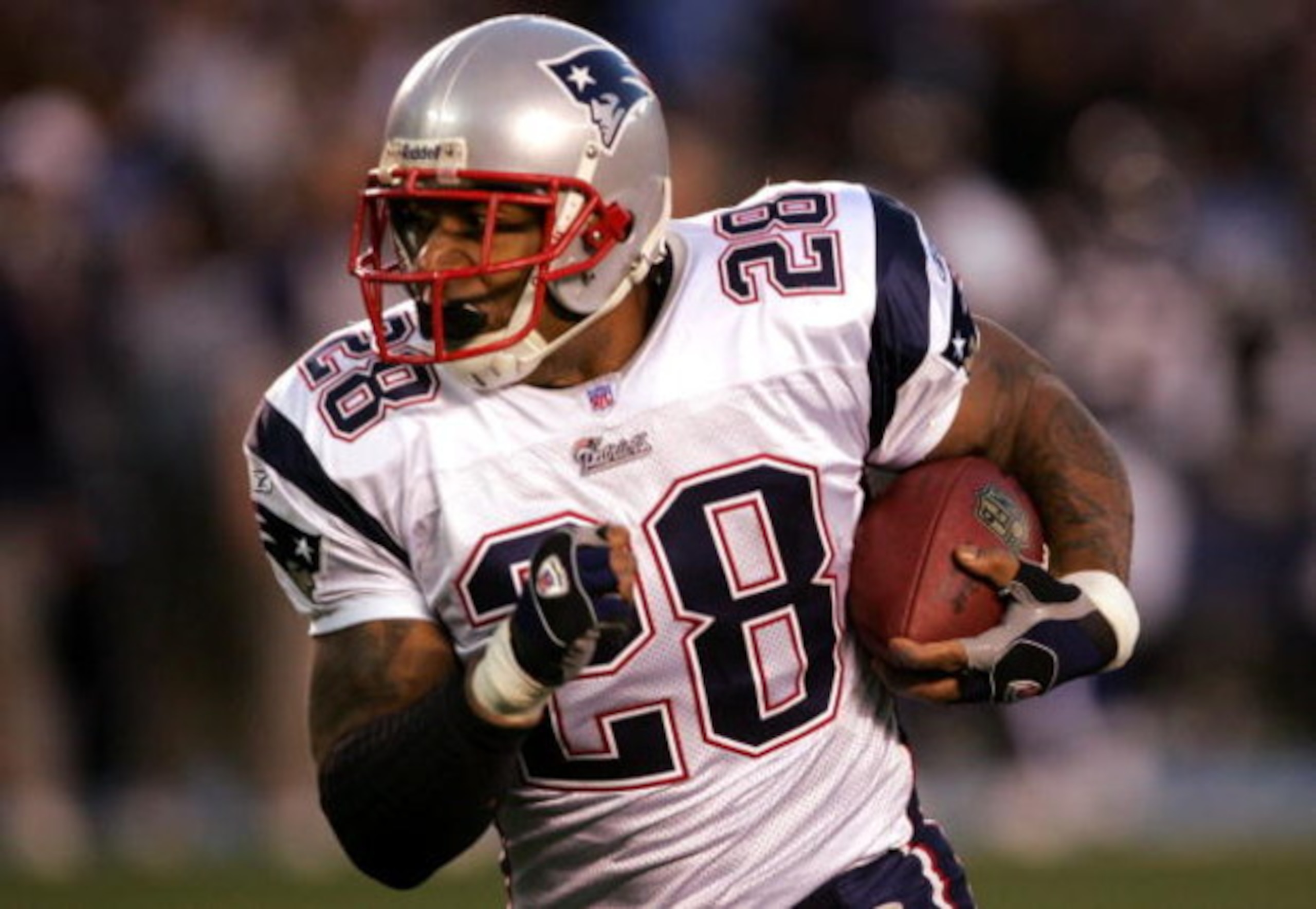 SAN DIEGO - JANUARY 14:  Runningback Corey Dillon #28 of the New England Patriots carries the ball against the San Diego Chargers during the AFC Divisional Playoff Game held at Qualcomm Stadium January 14, 2007 in San Diego, California. The Patriots defea