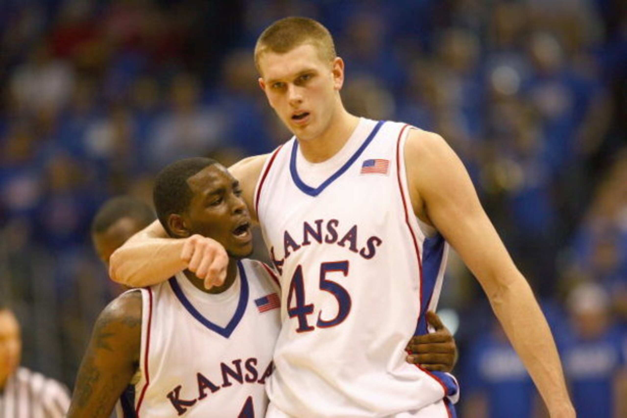LAWRENCE, KANSAS - JANUARY 3:  Sherron Collins #4 and Cole Aldrich #45 of the Kansas Jayhawks walk on court against the Tennessee Volunteers on January 3, 2009 at Allen Fieldhouse in Lawrence, Kansas. (Photo by: Jamie Squire/Getty Images)