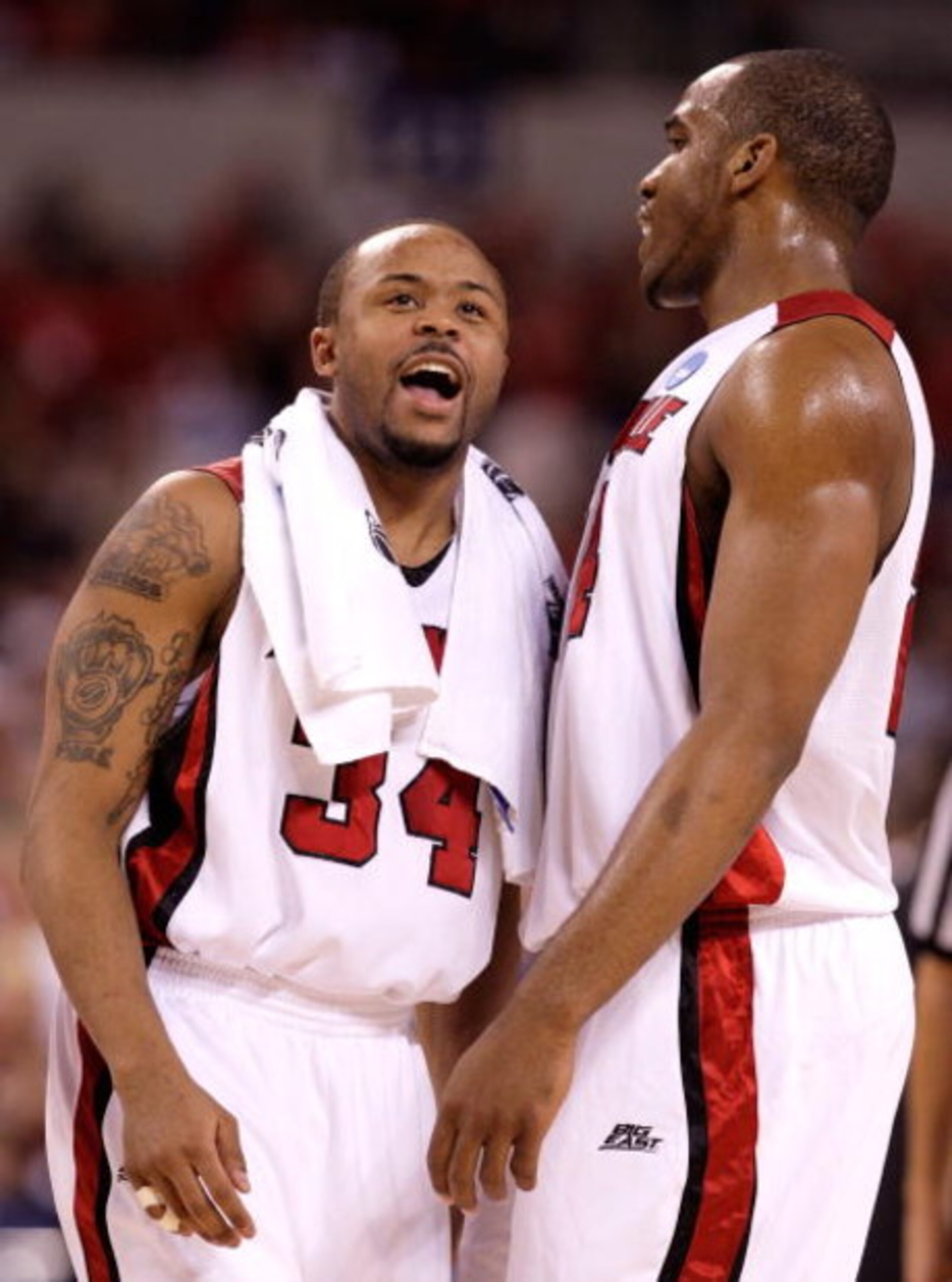 INDIANAPOLIS - MARCH 27:  (L-R) Jerry Smith #34 and Samardo Samuels #24 of the Louisville Cardinals react during a timeout against the Arizona Wildcats during the third round of the NCAA Division I Men's Basketball Tournament at the Lucas Oil Stadium on M