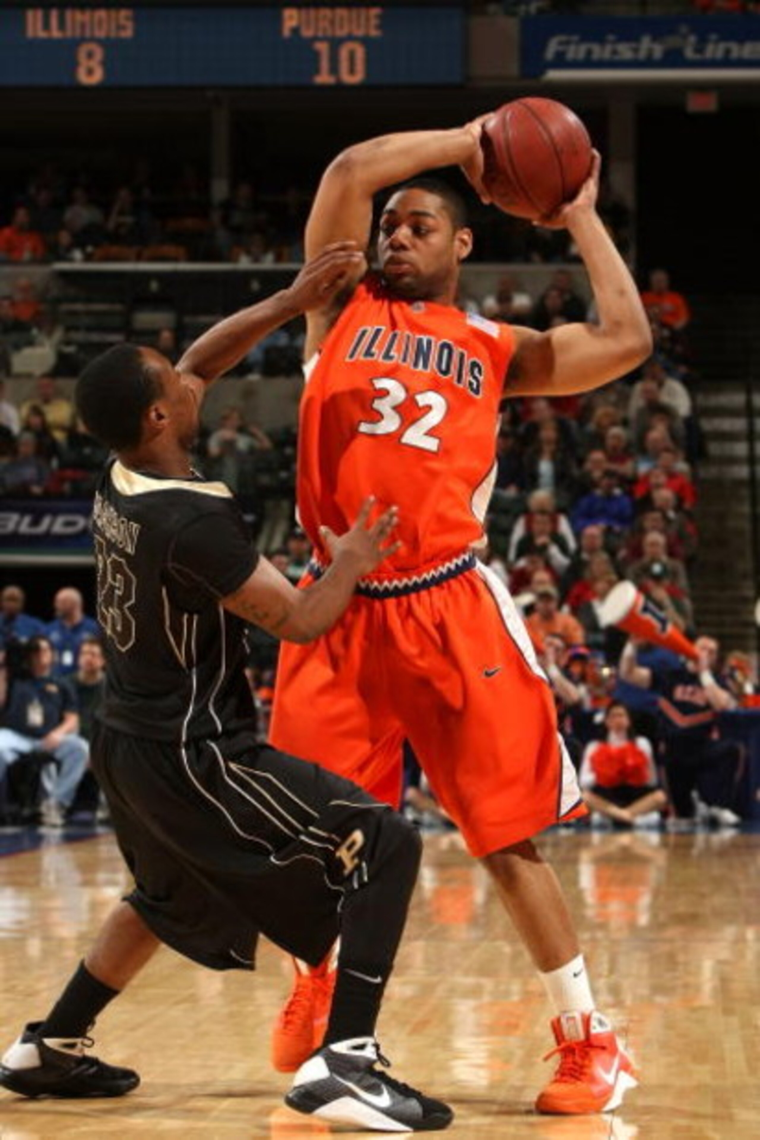 INDIANAPOLIS - MARCH 14:  Demetri McCamey #32 of the Illinois Fight Illini looks to pass the ball against Lewis Jackson #23 of the Purdue Boilermakers during their semifinal game of the Big Ten Men's Basketball Tournament at Conseco Fieldhouse on March 14