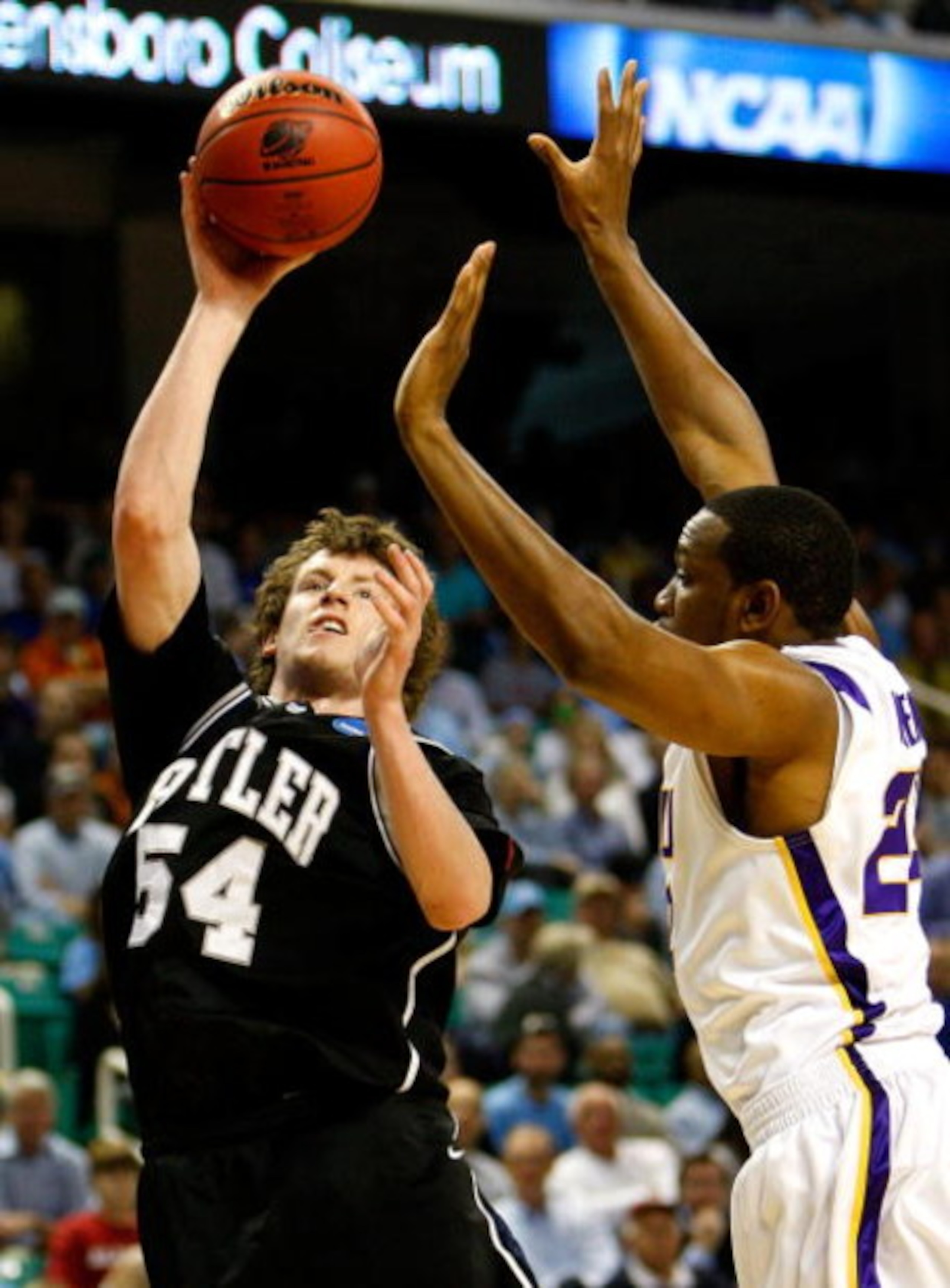 GREENSBORO, NC - MARCH 19:  Matt Howard #54 of the Butler Bulldogs shoots against Storm Warren #24 of the Louisiana State University Tigers during the first round of the NCAA Division I Men's Basketball Tournament at the Greensboro Coliseum on March 19, 2