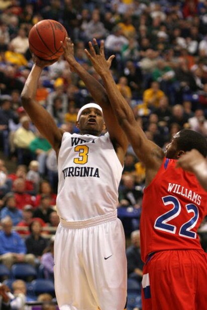 MINNEAPOLIS - MARCH 20:  Devin Ebanks #3 of the West Virginia Moutaineers attempts a shot against Paul Williams #22 of the Dayton Flyers during the first round of the NCAA Division I Men's Basketball Tournament at the Hubert H. Humphrey Metrodome on March