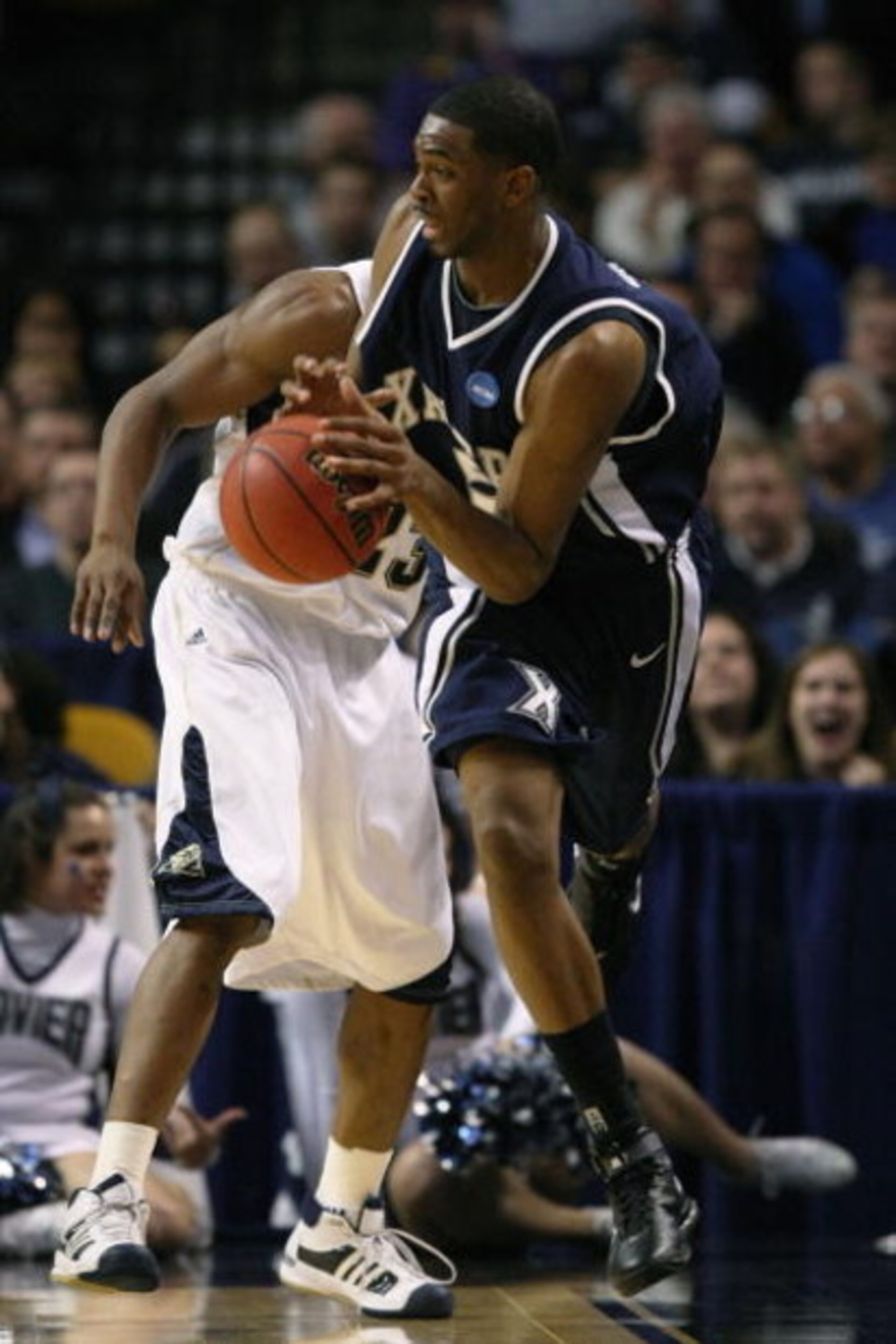 BOSTON - MARCH 26:  Sam Young #23 of the Pittsburgh Panthers and Derrick Brown #5 of the Xavier Musketeers fight to keep the ball in bounds during the NCAA Men's Basketball Tournament East Regionals at TD Banknorth Garden on March 26, 2009 in Boston, Mass