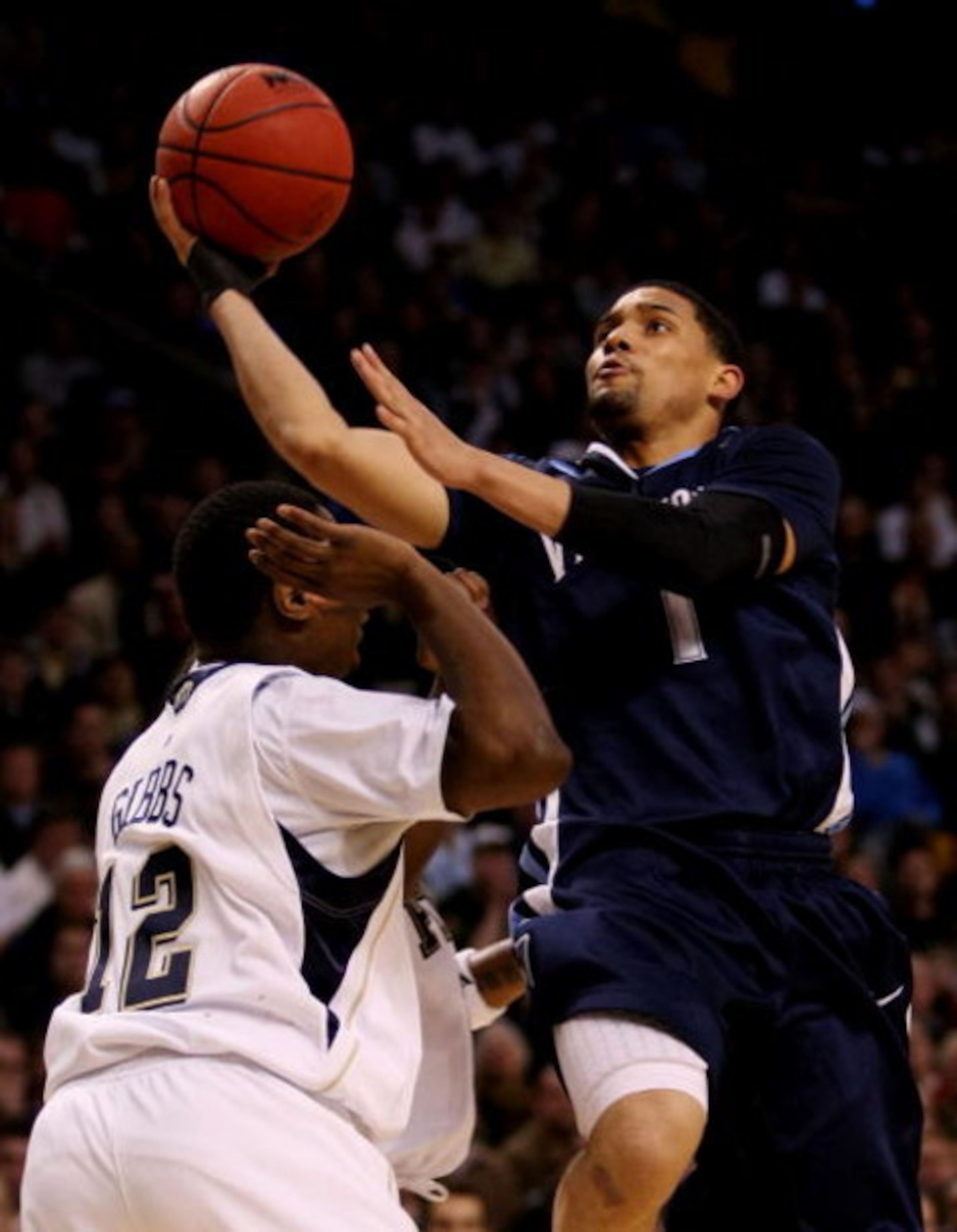 BOSTON - MARCH 28:  Scottie Reynolds #1 of the Villanova Wildcats puts up a shot over Ashton Gibbs #12 of the Pittsburgh Panthers during the NCAA Men's Basketball Tournament East Regionals at TD Banknorth Garden on March 28, 2009 in Boston, Massachusetts.