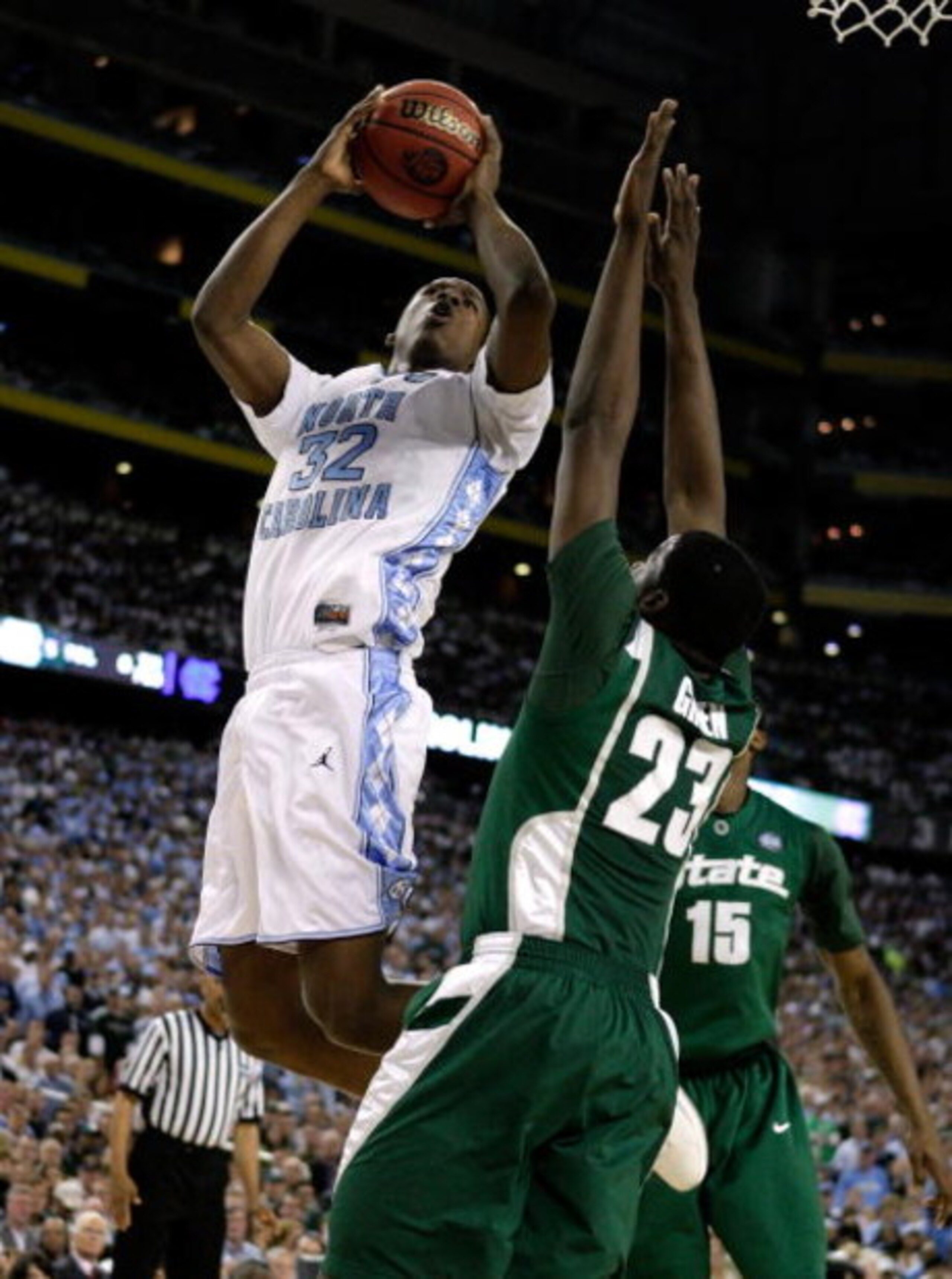 DETROIT - APRIL 06:  Ed Davis #32 of the North Carolina Tar Heels drives for a shot attempt in the first half against Draymond Green #23 of the Michigan State Spartans during the 2009 NCAA Division I Men's Basketball National Championship game at Ford Fie