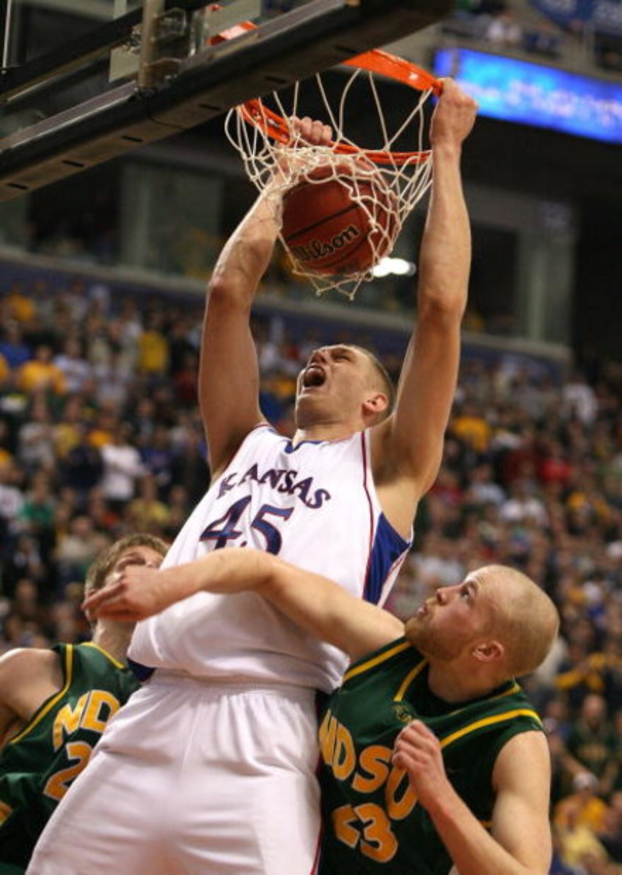 MINNEAPOLIS - MARCH 20:  Cole Aldrich #45 of the Kansas Jayhawks dunks against Michael Tveidt #23 of the North Dakota State Bison in the second half during the first round of the NCAA Division I Men's Basketball Tournament at the Hubert H. Humphrey Metrod