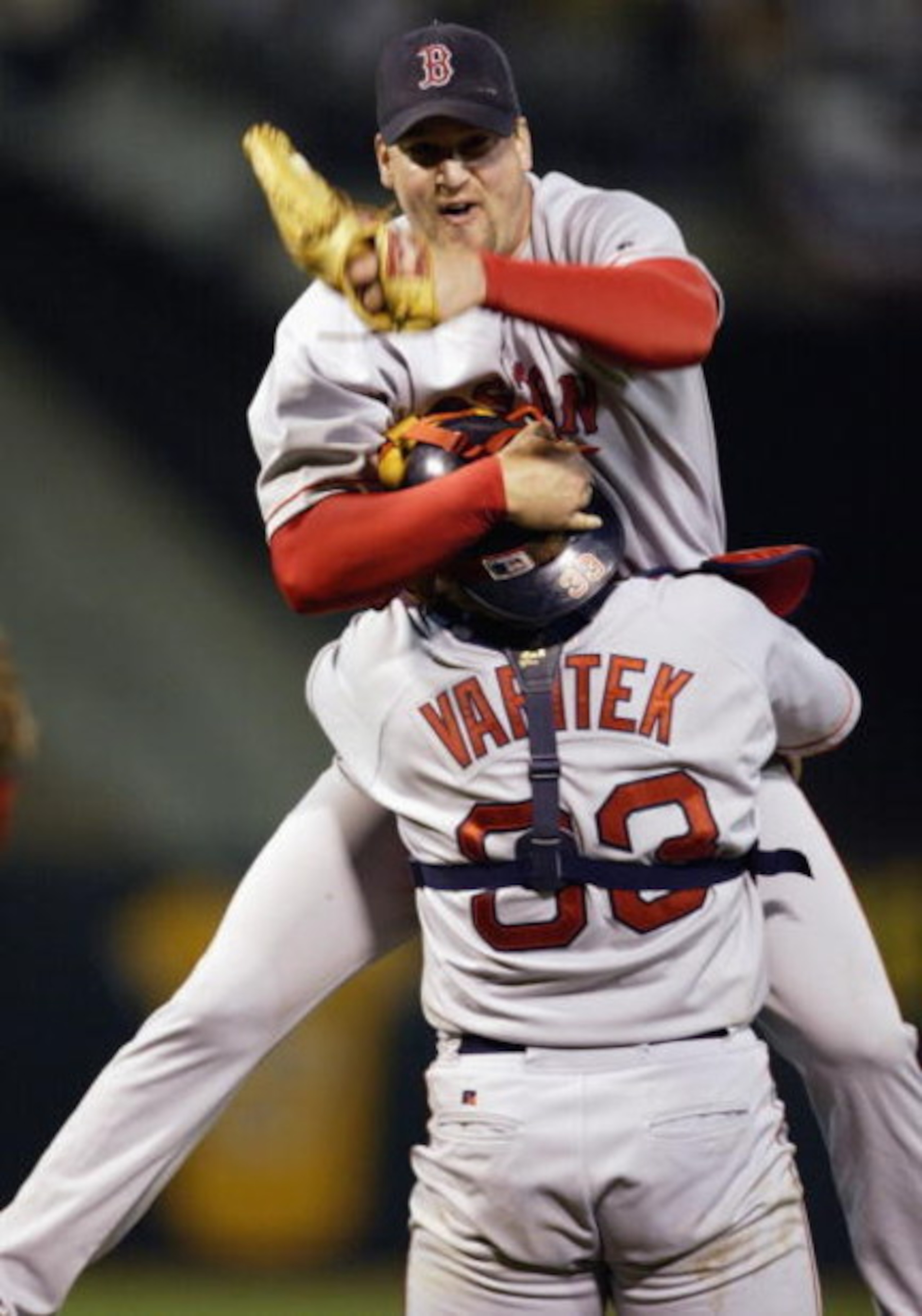 OAKLAND, CA - OCTOBER 6:  Derek Lowe #32 of the Boston Red Sox jumps into the arms of Jason Varitek #33 after the victory over the Oakland A's in game 5 of the 2003 American League Divisional Series at the Network Associates Coliseum on October 6, 2003 in